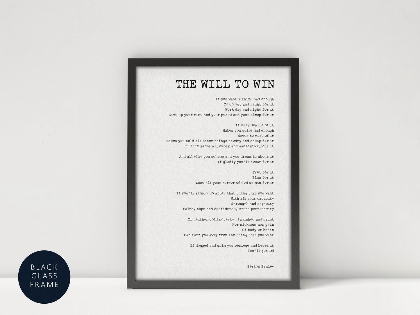 a framed black and white photograph of a person&#39;s face, with the text &quot;The Will to Win&quot; written in a black font on a white background.