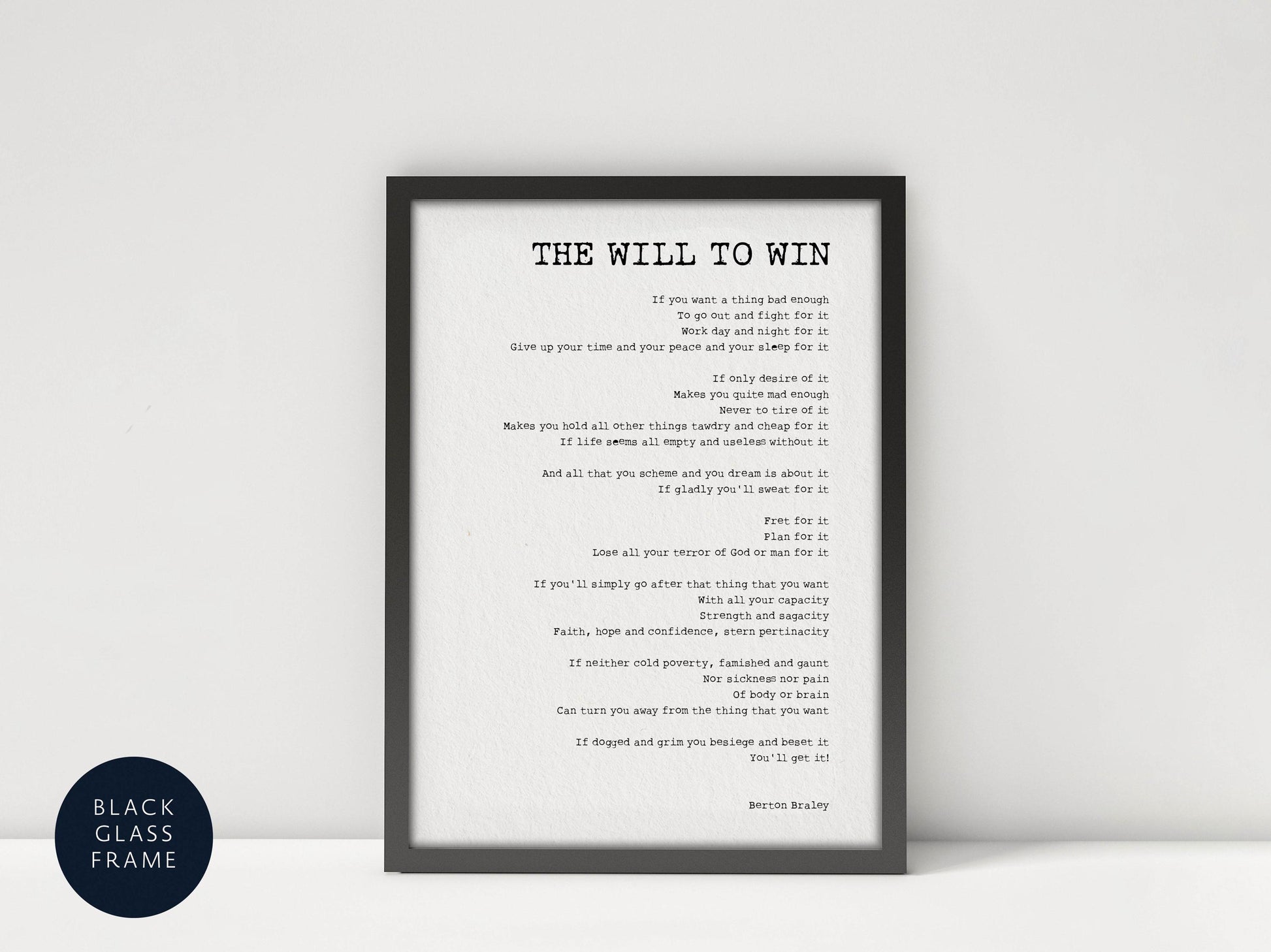 a framed black and white photograph of a person&#39;s face, with the text &quot;The Will to Win&quot; written in a black font on a white background.