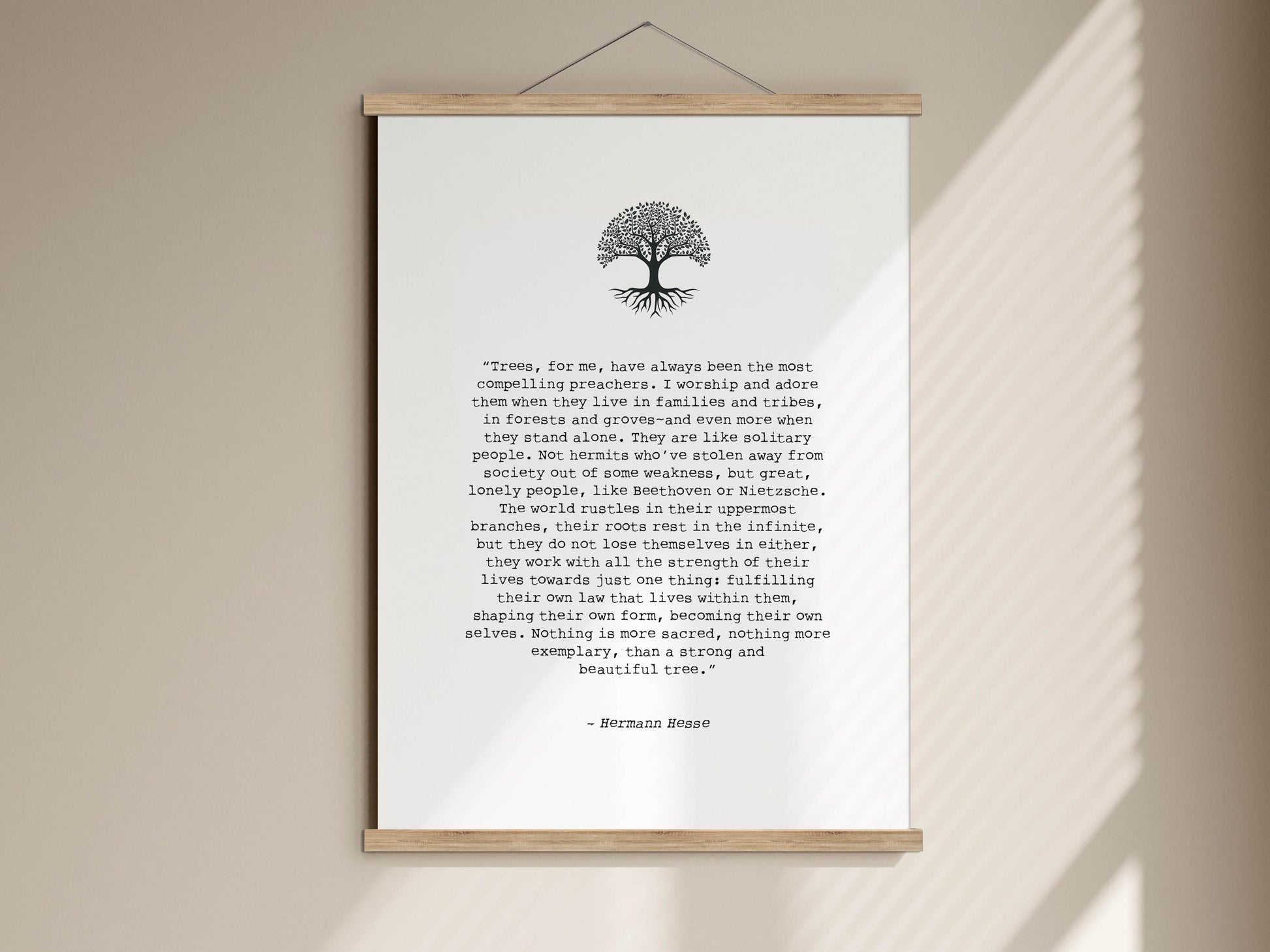 The image is a poster with a quote by Hermann Hesse, which is a piece of literature. The quote is about the importance of trees and their connection to the spiritual world. The poster is framed and mounted on a wall, and the text is written in a serif font.