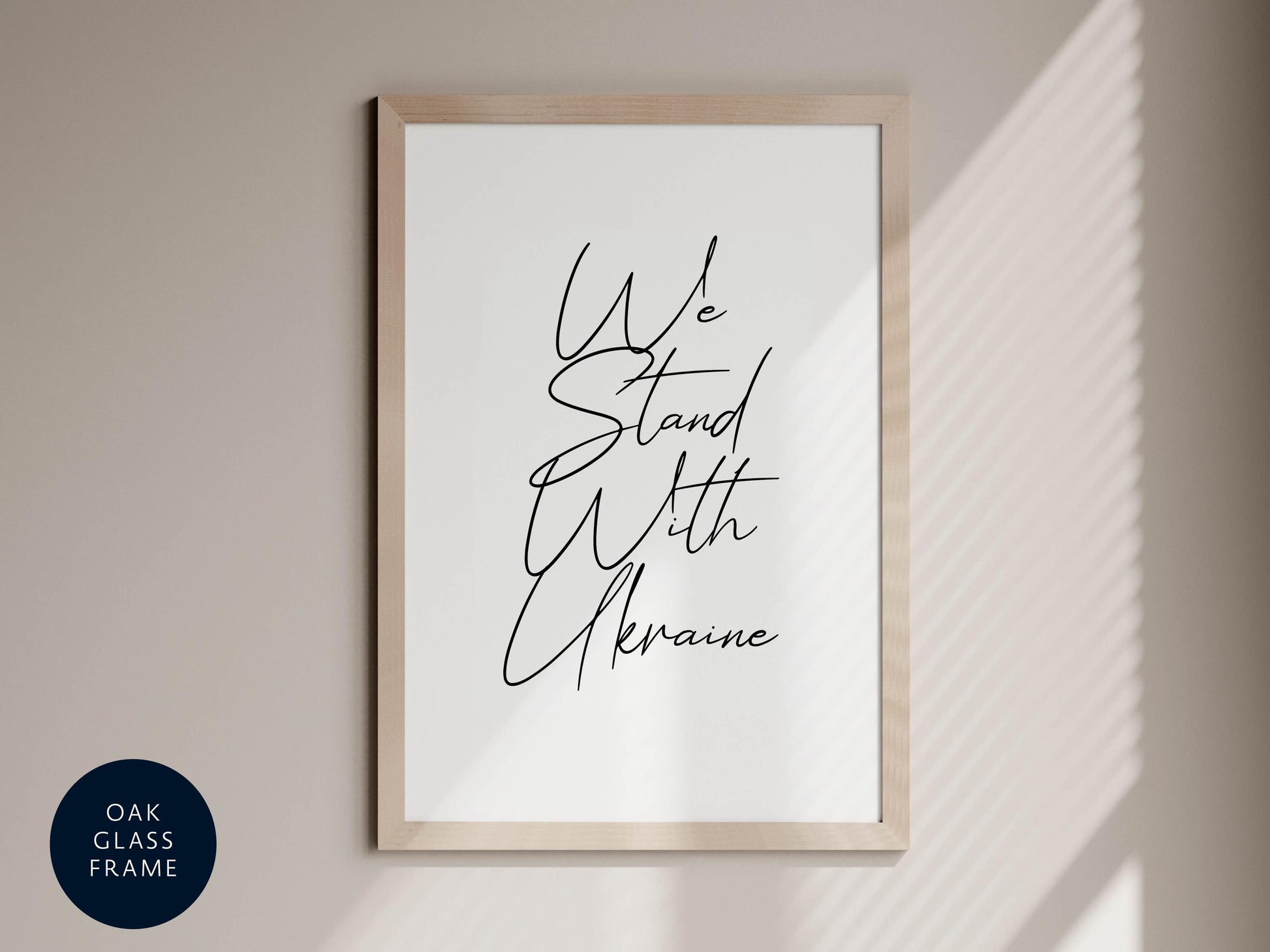 a framed poster with the text &quot;We Stand With Ukraine&quot; written on it.