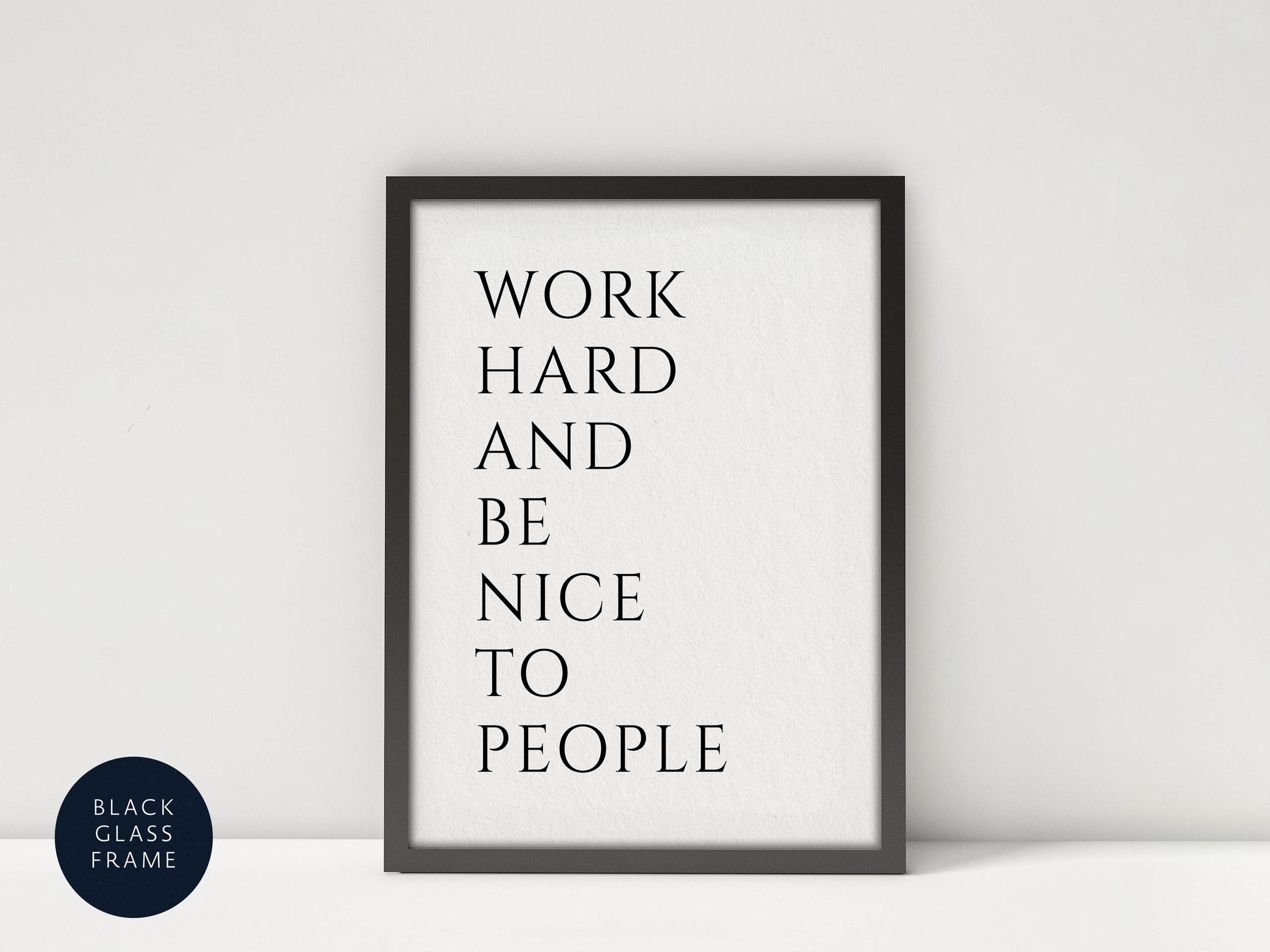 a framed poster with the text &quot;WORK HARD AND BE NICE TO PEOPLE&quot; written on it.