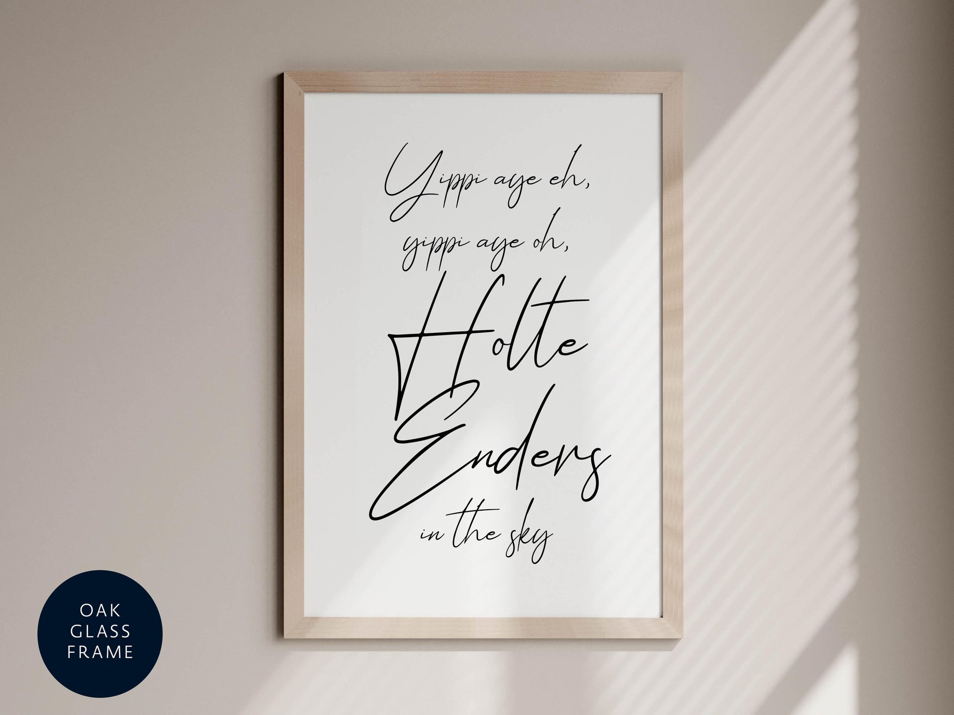 a framed poster with the text &quot;Yippee age, gippee age, oh, Holte Endens in the sky&quot; written in a cursive font.