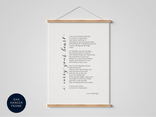 a framed poem titled &quot;I carry your heart with me&quot; by e.c. Cunningham. The poem is written in a cursive font and is displayed on a white background. The poem is hung on a wall, and the text is described in a conversational style.
