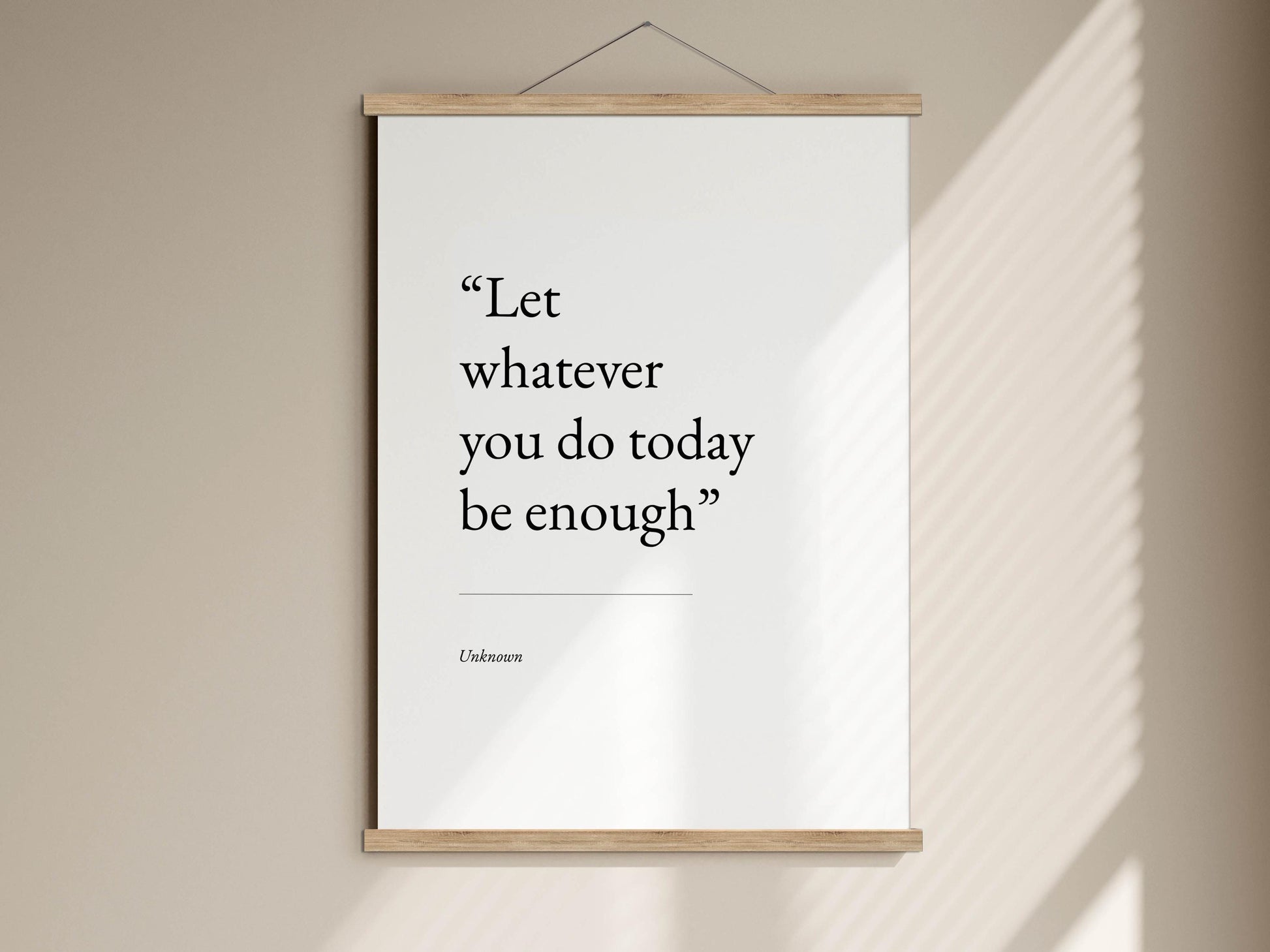 a quote poster hanging on a wall, which reads &quot;Let whatever you do today be enough&quot;.