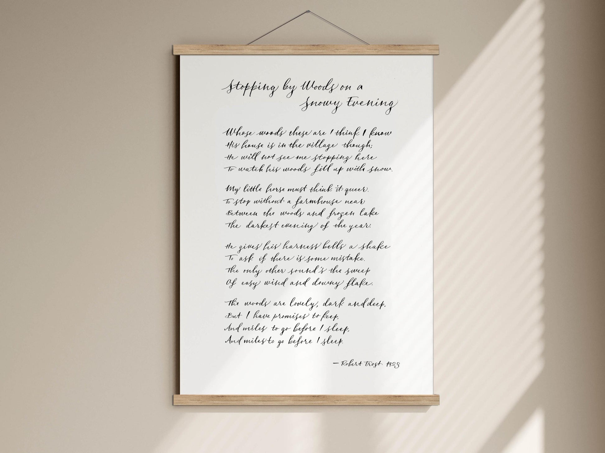 a framed poem titled &quot;Stepping by Woods on a Snowy Evening&quot; by Robert Frost, which is a classic work of literature.