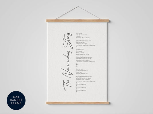 a white poster with black text, hanging on a wall. The text appears to be a poem or lyrics, and it is not possible to provide a detailed description of the content without seeing the image.