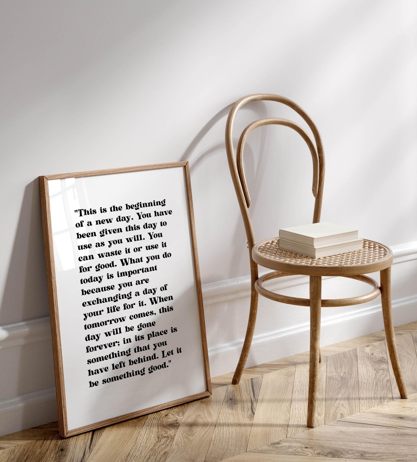 a wooden chair with a white book on it, placed against a white wall.