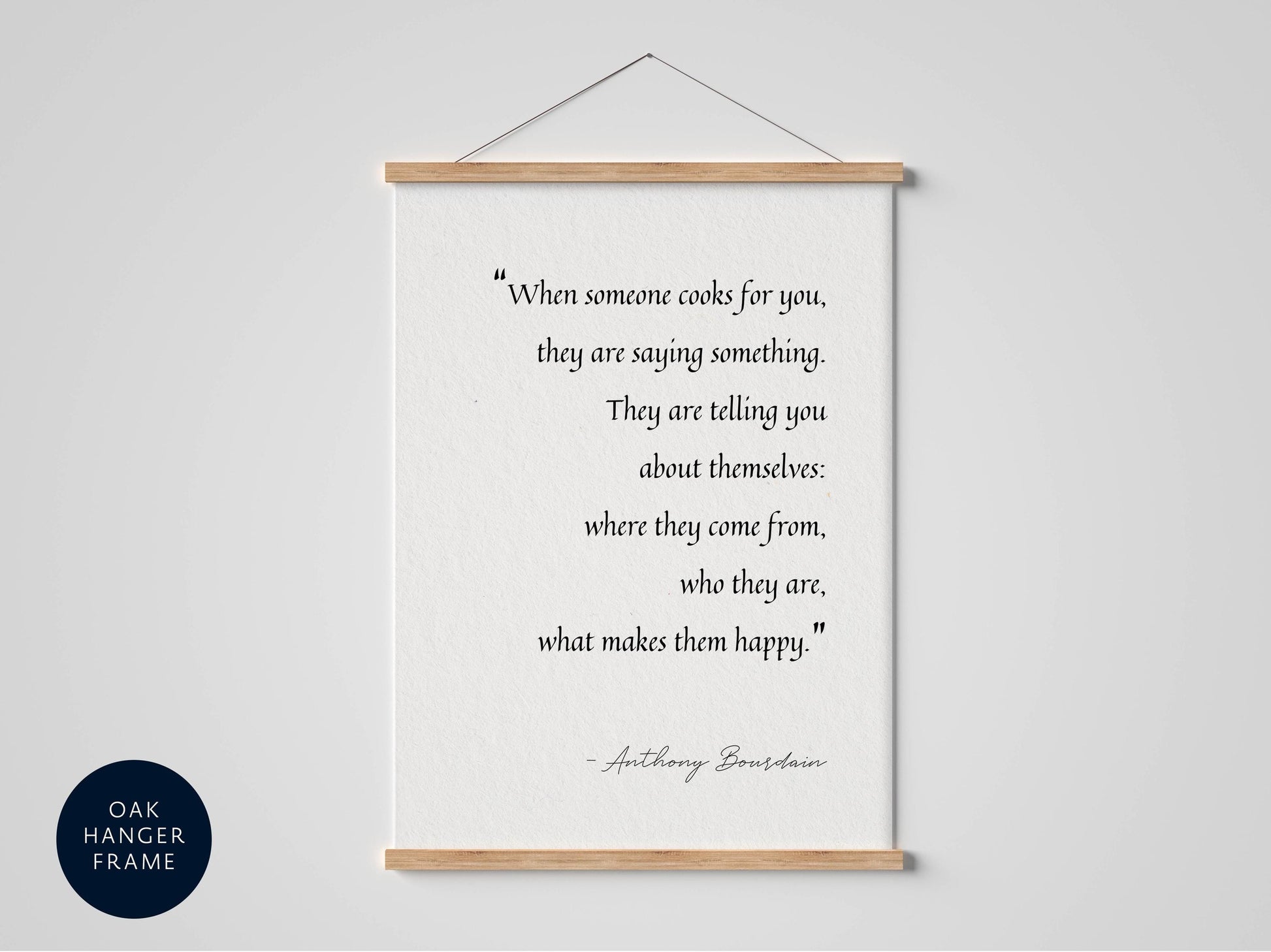 a quote by Anthony Bourdain hanging on a wall, which reads: &quot;When someone cooks for you, they are saying something. They are telling you about themselves: where they come from, who they are, what makes them happy.&quot;