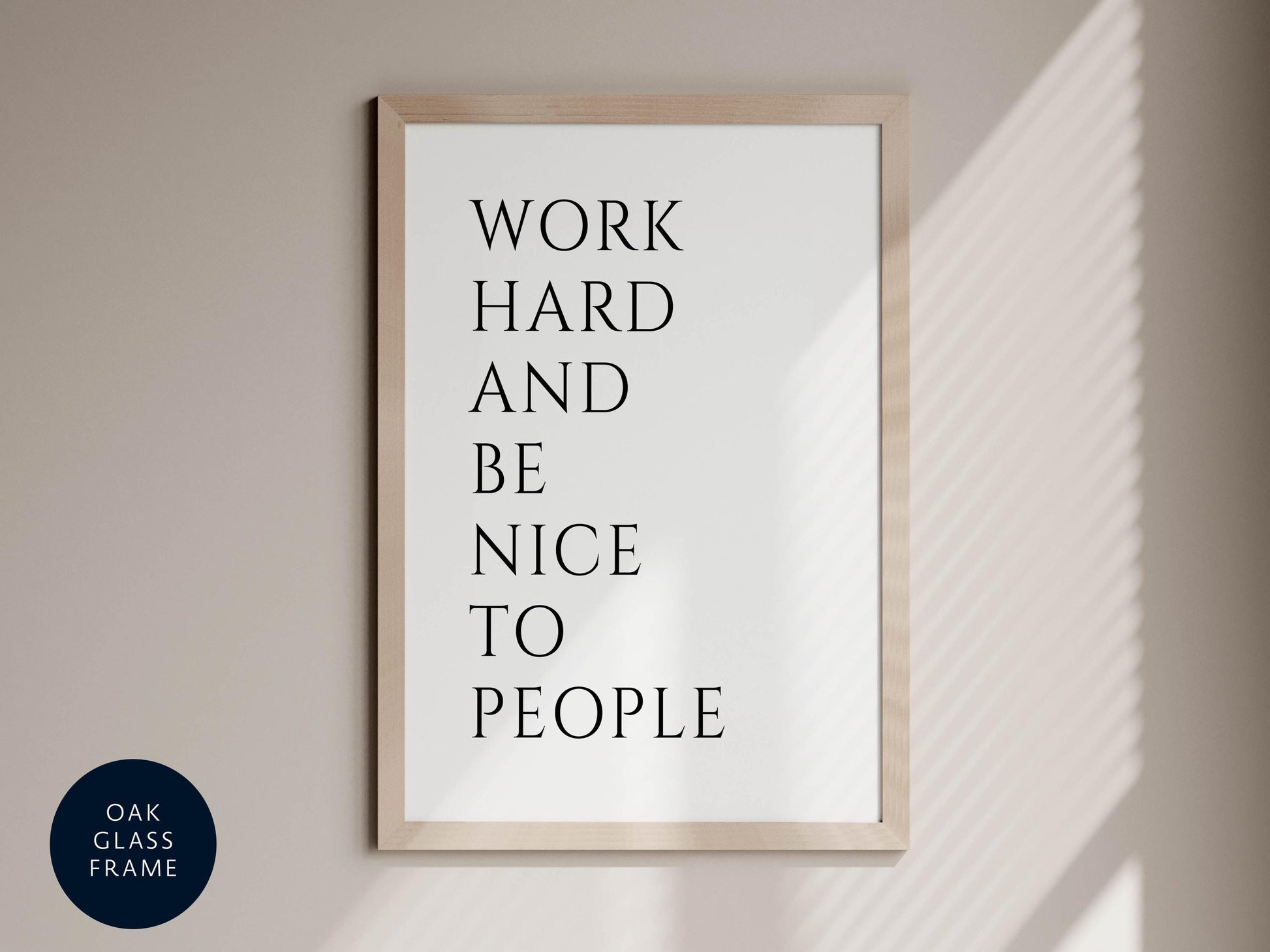a framed poster with the text &quot;WORK HARD AND BE NICE TO PEOPLE&quot; displayed on it.