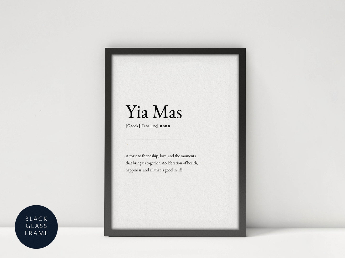 A framed definition of &#39;Yia Mas&#39; against a white background, with a black border.