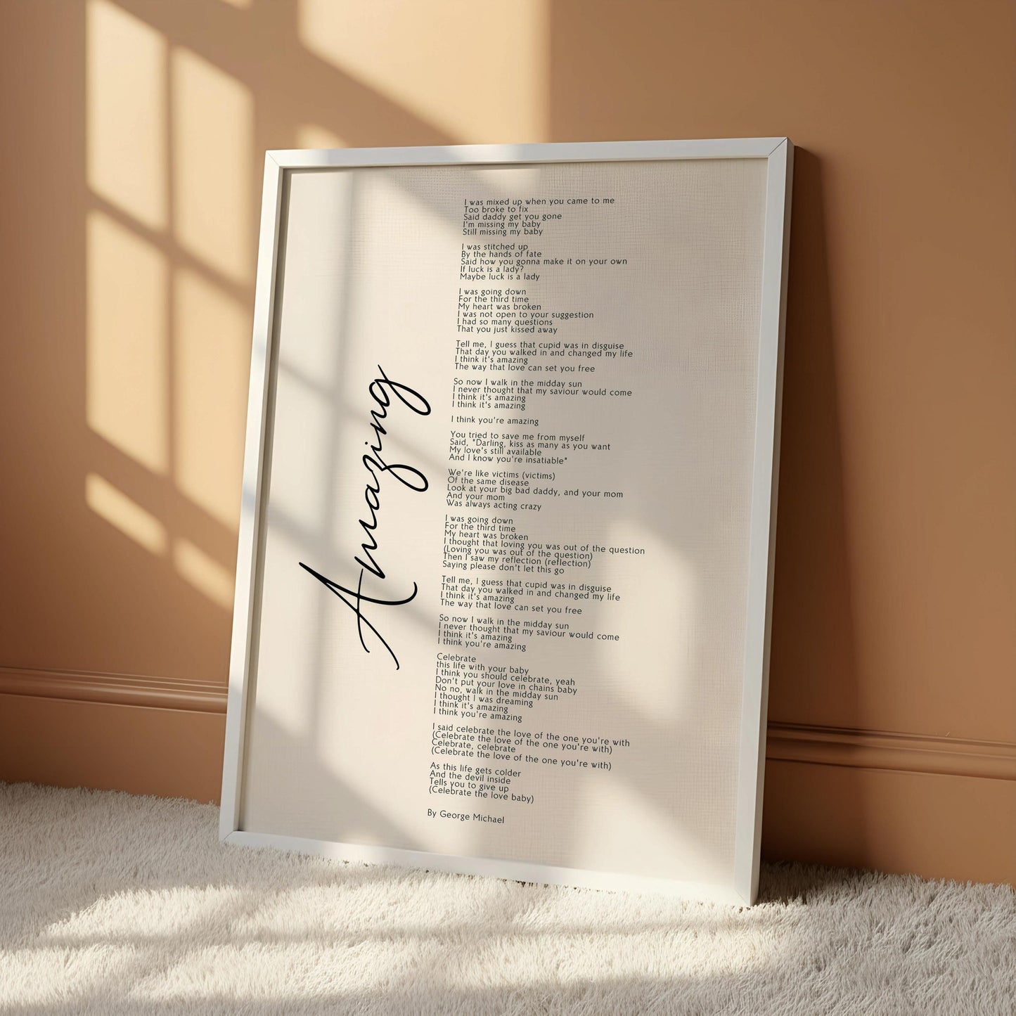 a white poster with black text, hanging on a wall. The poster appears to be a song or poem, with the word "Amazing" written in cursive at the bottom.