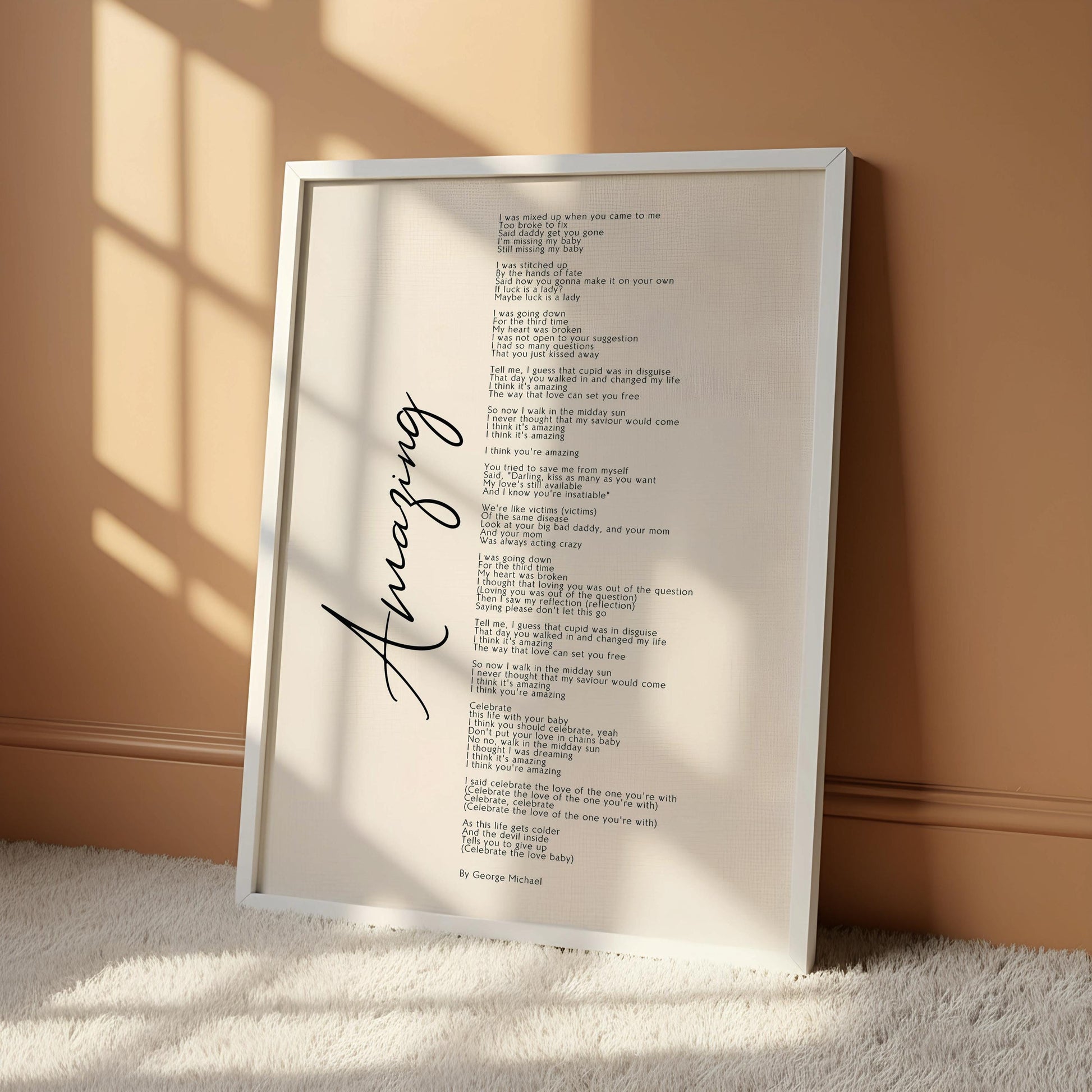 a white poster with black text, hanging on a wall. The poster appears to be a song or poem, with the word "Amazing" written in cursive at the bottom.