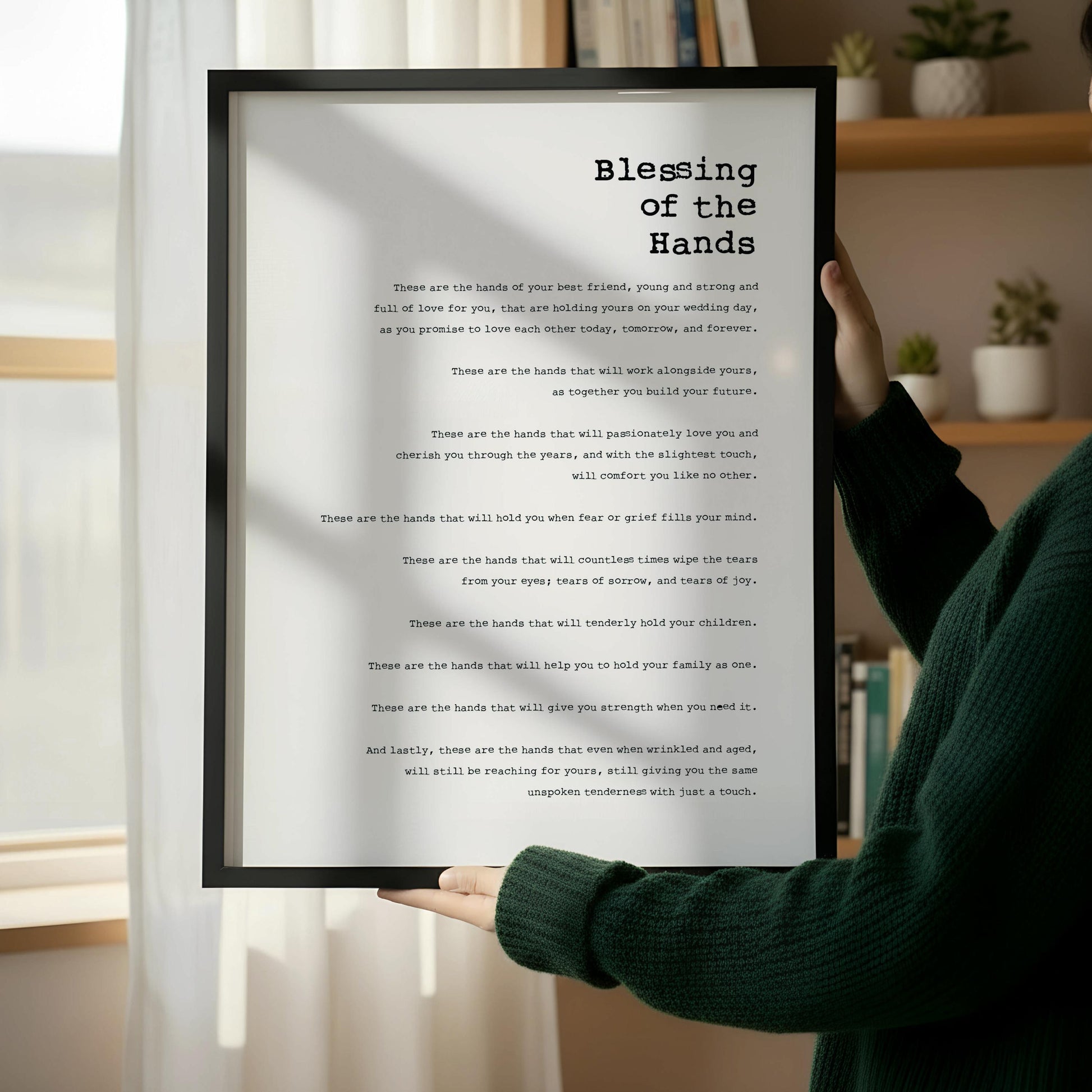 a framed text that reads "Blessing of the Hands" in a black and white color scheme.