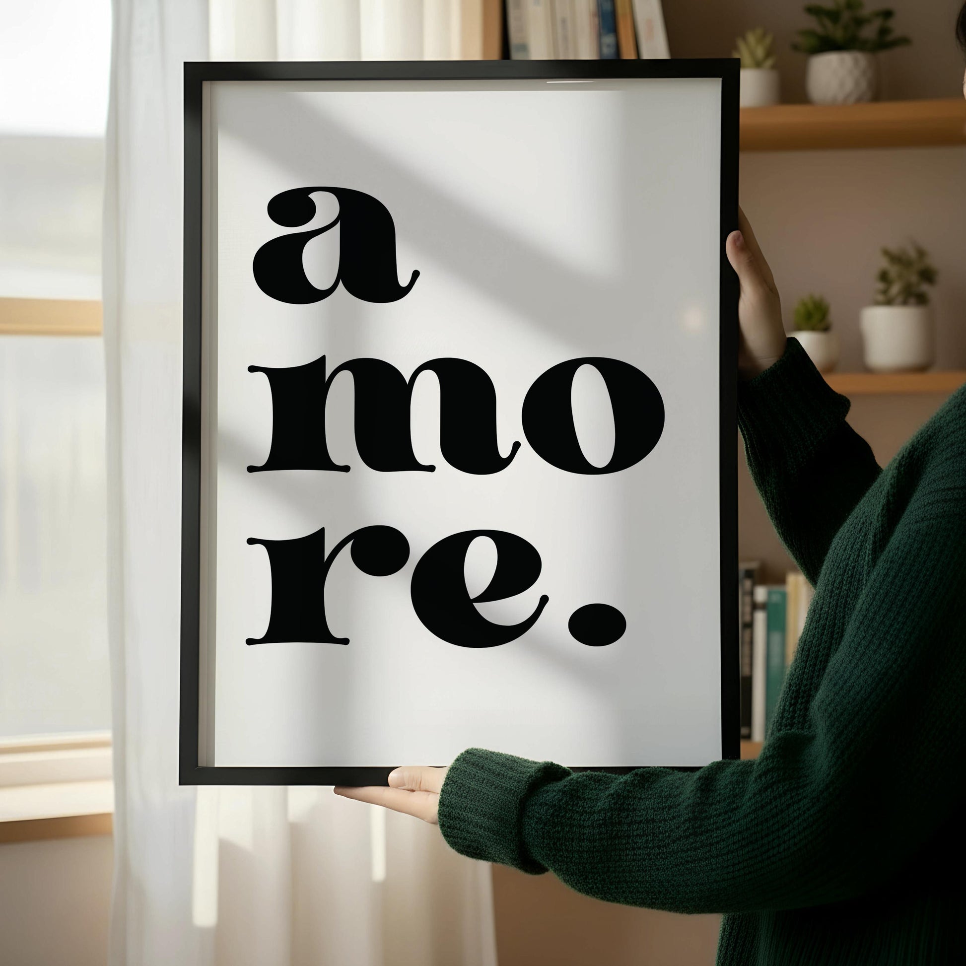 a wooden chair with a book resting on it, positioned next to a framed poster with the text "a more."