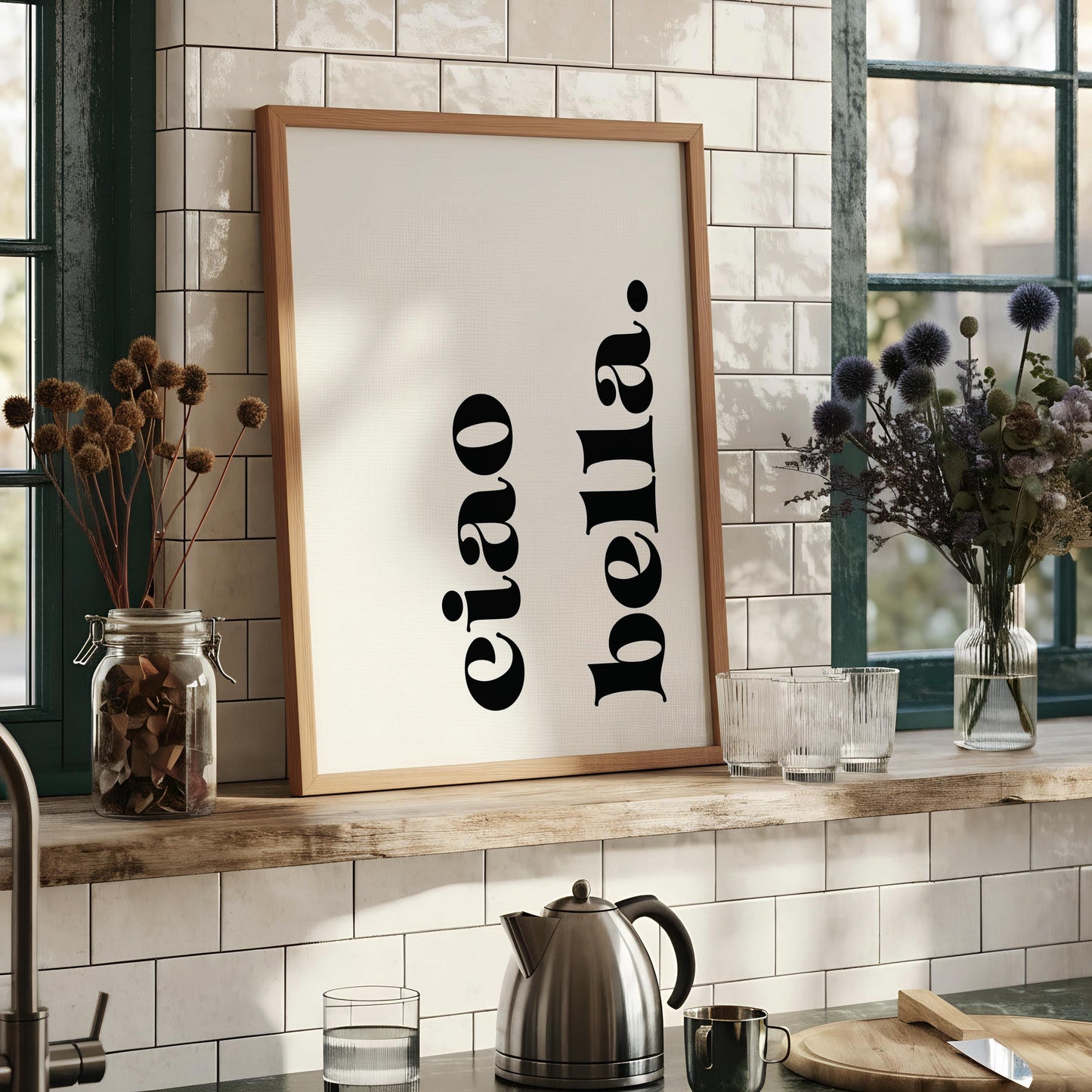 a framed print with the text "eiao bella" in a minimalist black font against a white background.