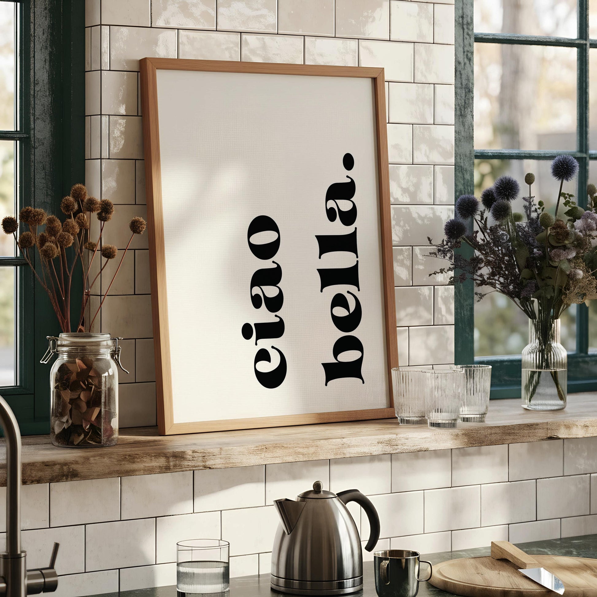 a framed print with the text "eiao bella" in a minimalist black font against a white background.