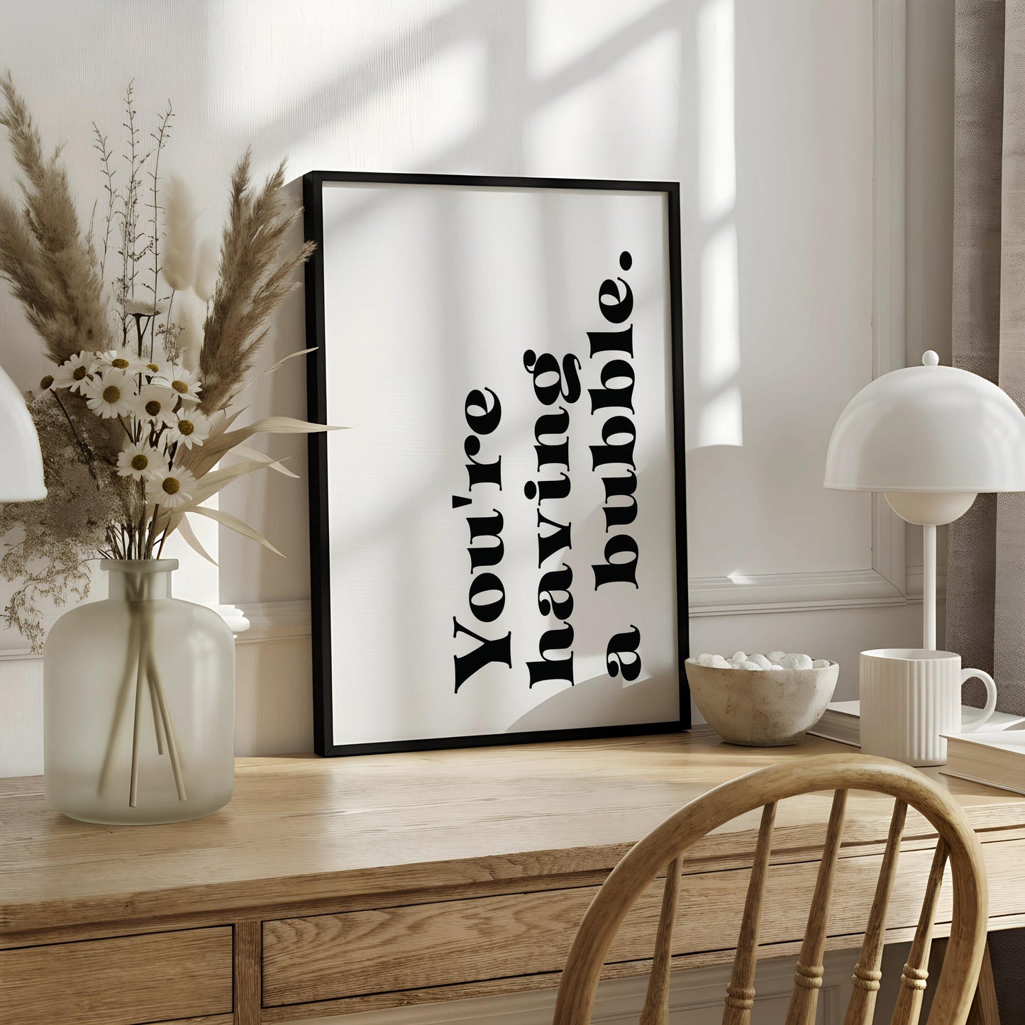 A framed poster with the text "You're having a bubble" displayed on it.