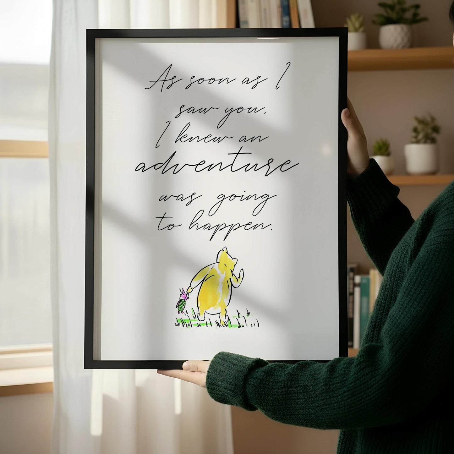 a framed quote with a yellow duck on a wooden floor next to a wooden chair.