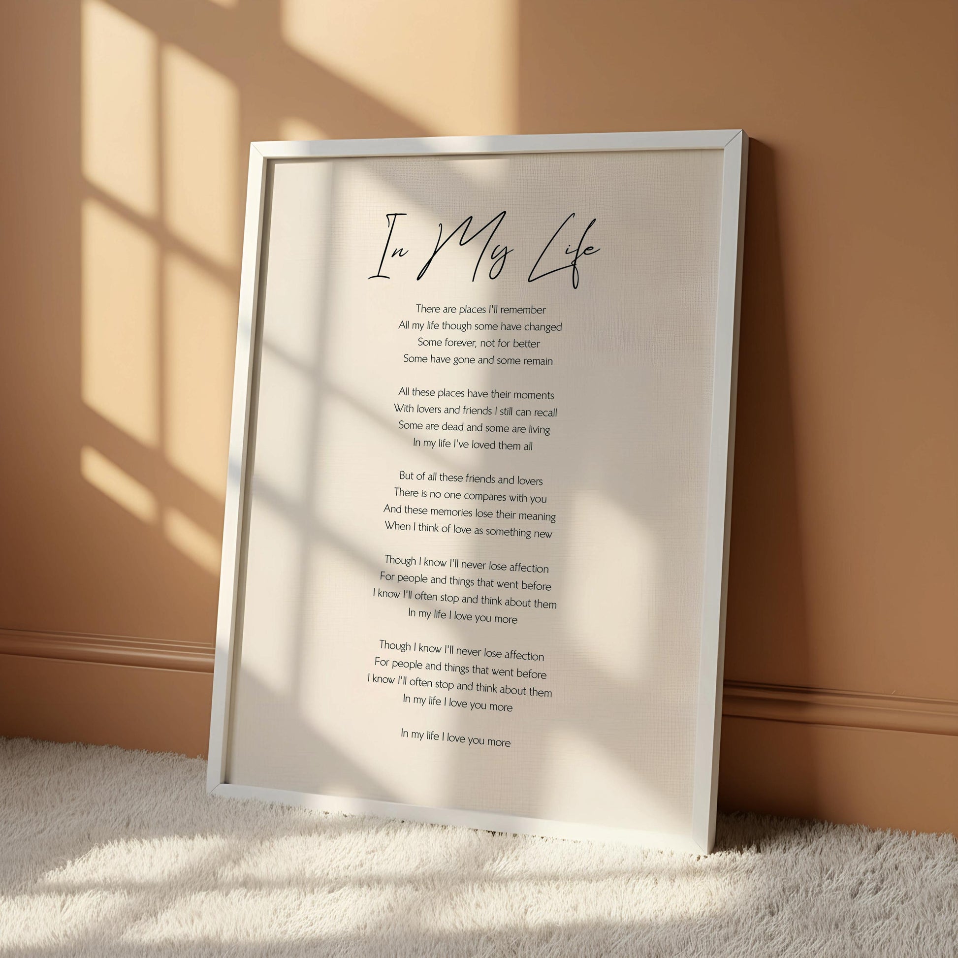 a framed piece of paper with a poem written on it, hanging on a wall. The poem is titled "In My Life" and it contains a heartfelt message about the passage of time and the importance of cherishing loved ones. The poem reflects on the memories and relationships that have been cherished over the years, and it encourages the reader to appreciate the time spent with loved ones. The image does not contain any additional information beyond the poem and the frame it is hanging in.