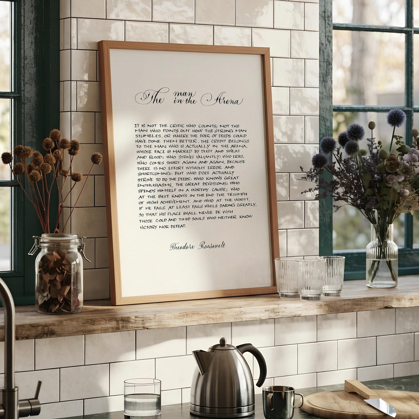 a framed text that reads "The man in the arena" in a cursive font.