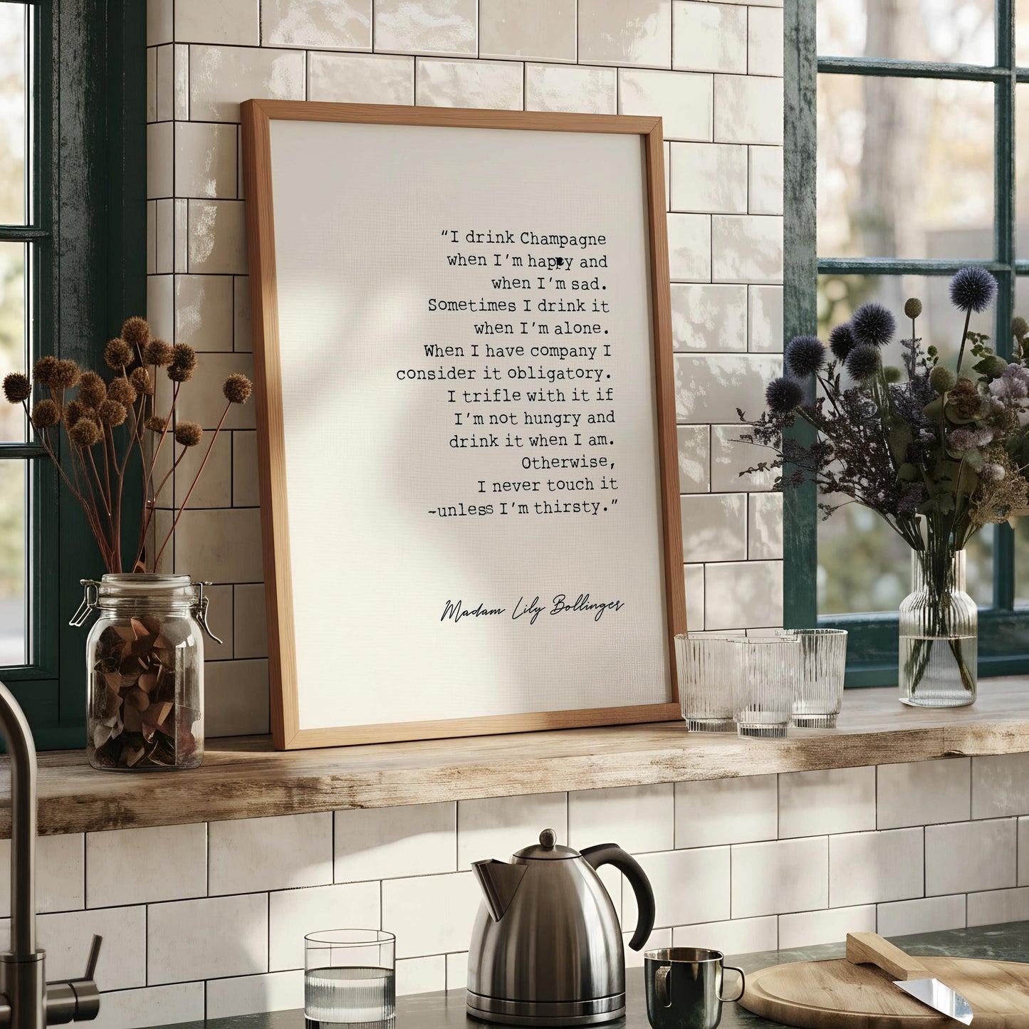 a framed quote by Maudubon Lilly Bellinger, which reads: "I drink Champagne when I'm happy and sad. Sometimes I drink it when I'm alone. When I have company I consider it optional. I trifle with it if I'm not hungry and drink it when I'm hungry, otherwise, I never touch it - unless I'm thirsty."