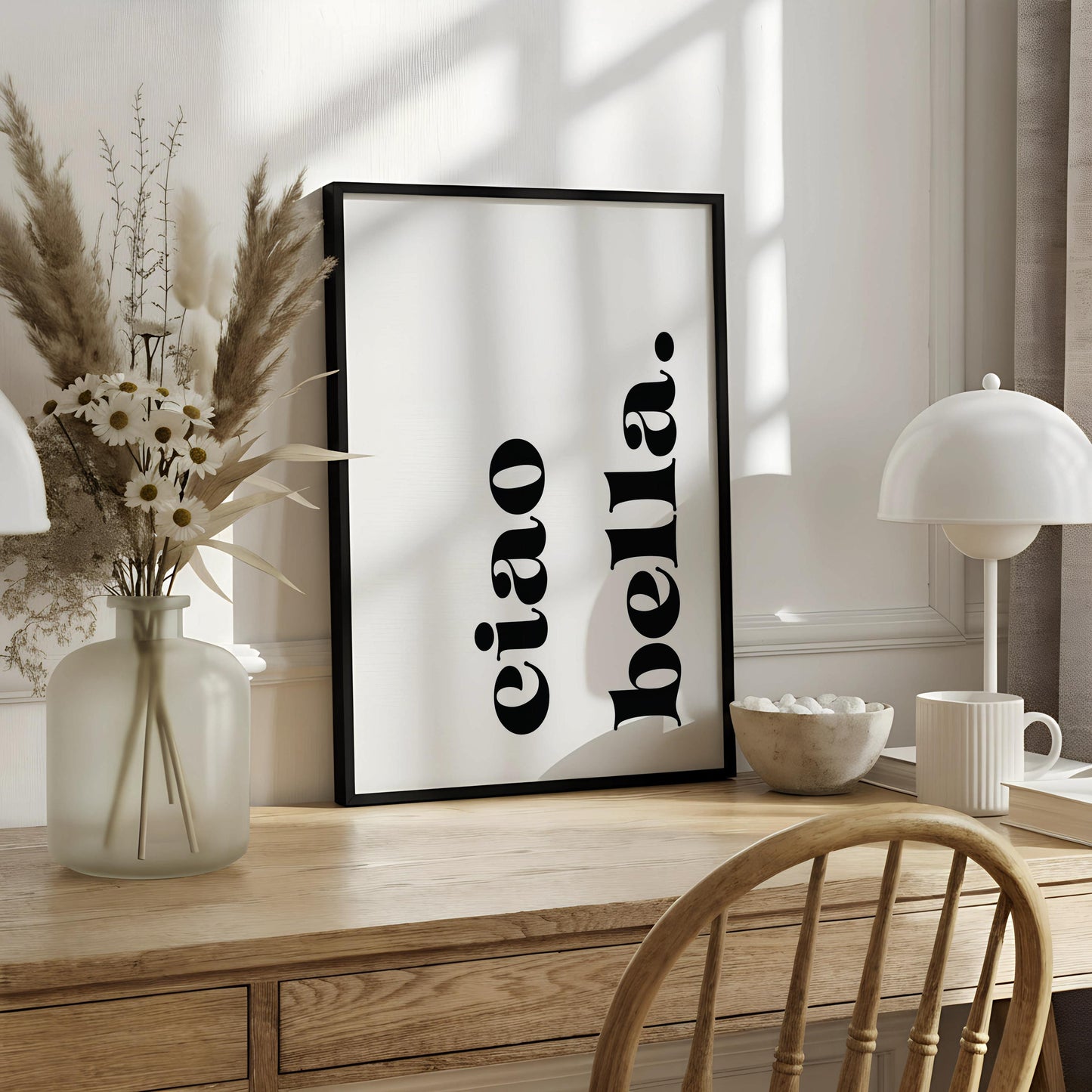 a white poster with black text that reads "eiao" and "bella".