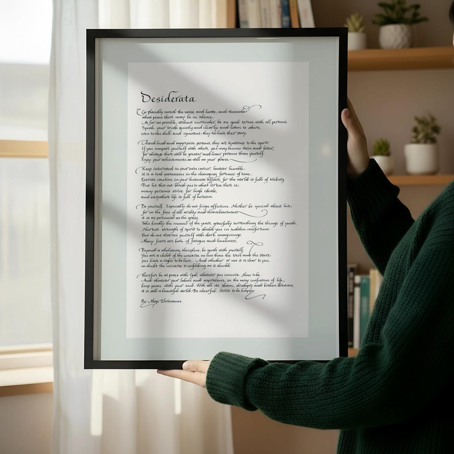 a wooden chair with a book resting on it, positioned next to a framed text that appears to be a poem or a quote.