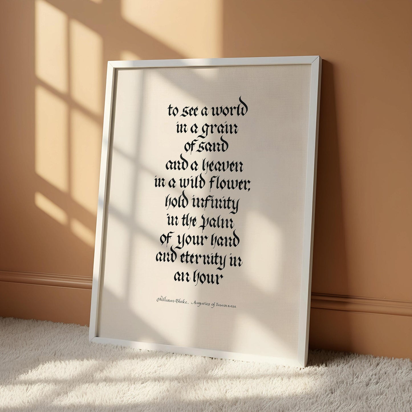 a framed quote in black text on a white background, hanging on a wall.