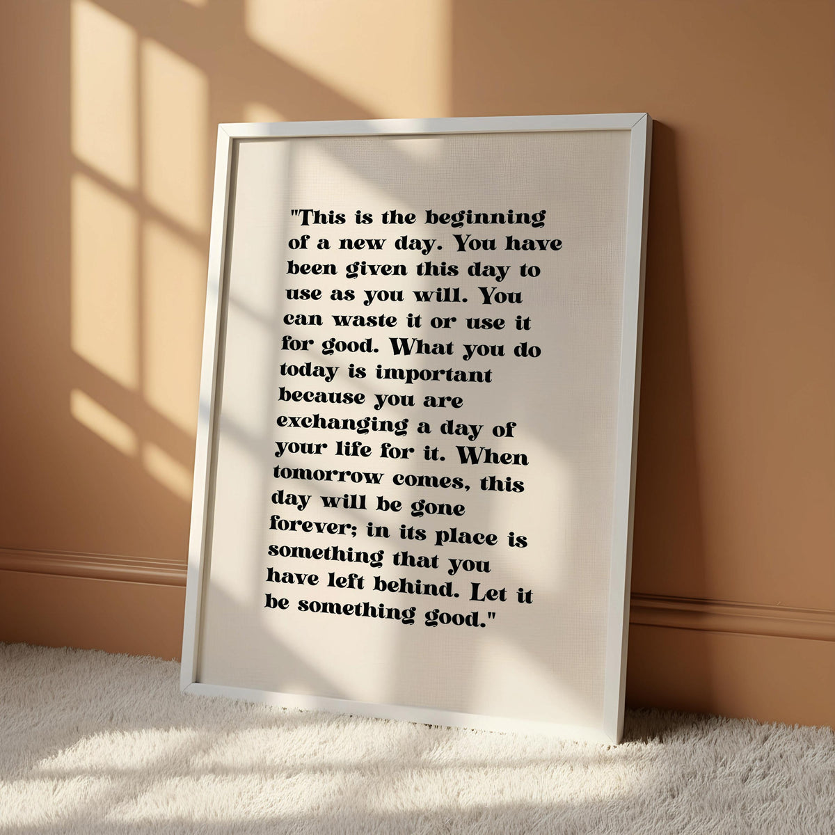 a quote on a white background, hanging on a wall.