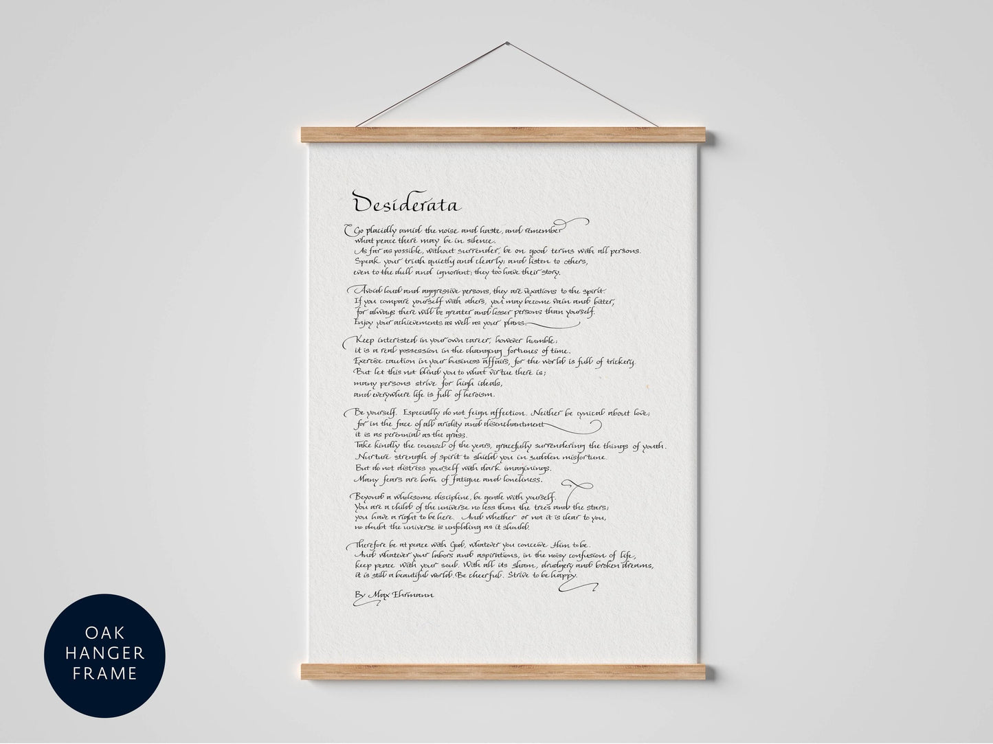 a framed print of a handwritten poem titled "Desireata" hanging on a wall.