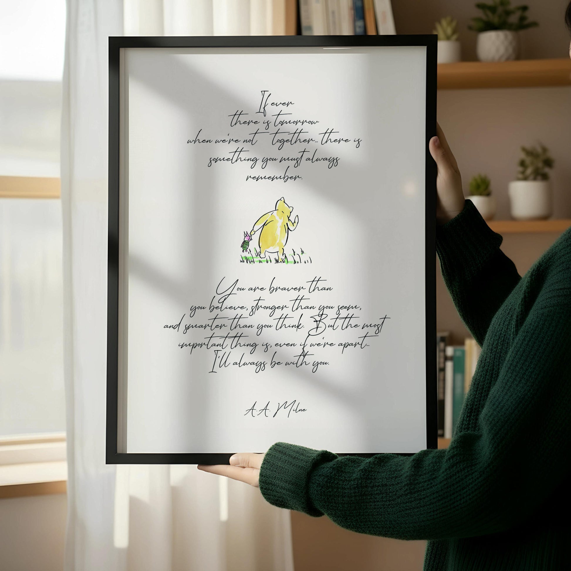 a wooden chair with a book resting on it, positioned next to a framed quote on a white wall.