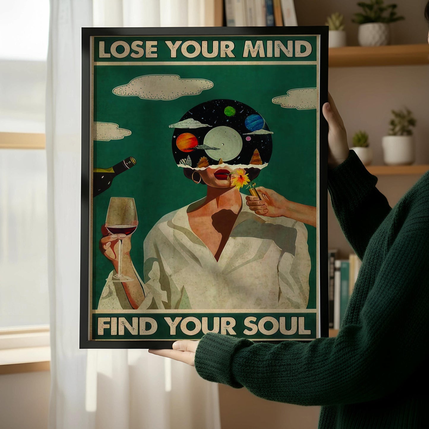 a framed poster with the text "LOSE YOUR MIND FIND YOUR SOUL" and an illustration of a person with a head full of planets. The poster is leaning against a wall, and there is a wooden chair next to it.