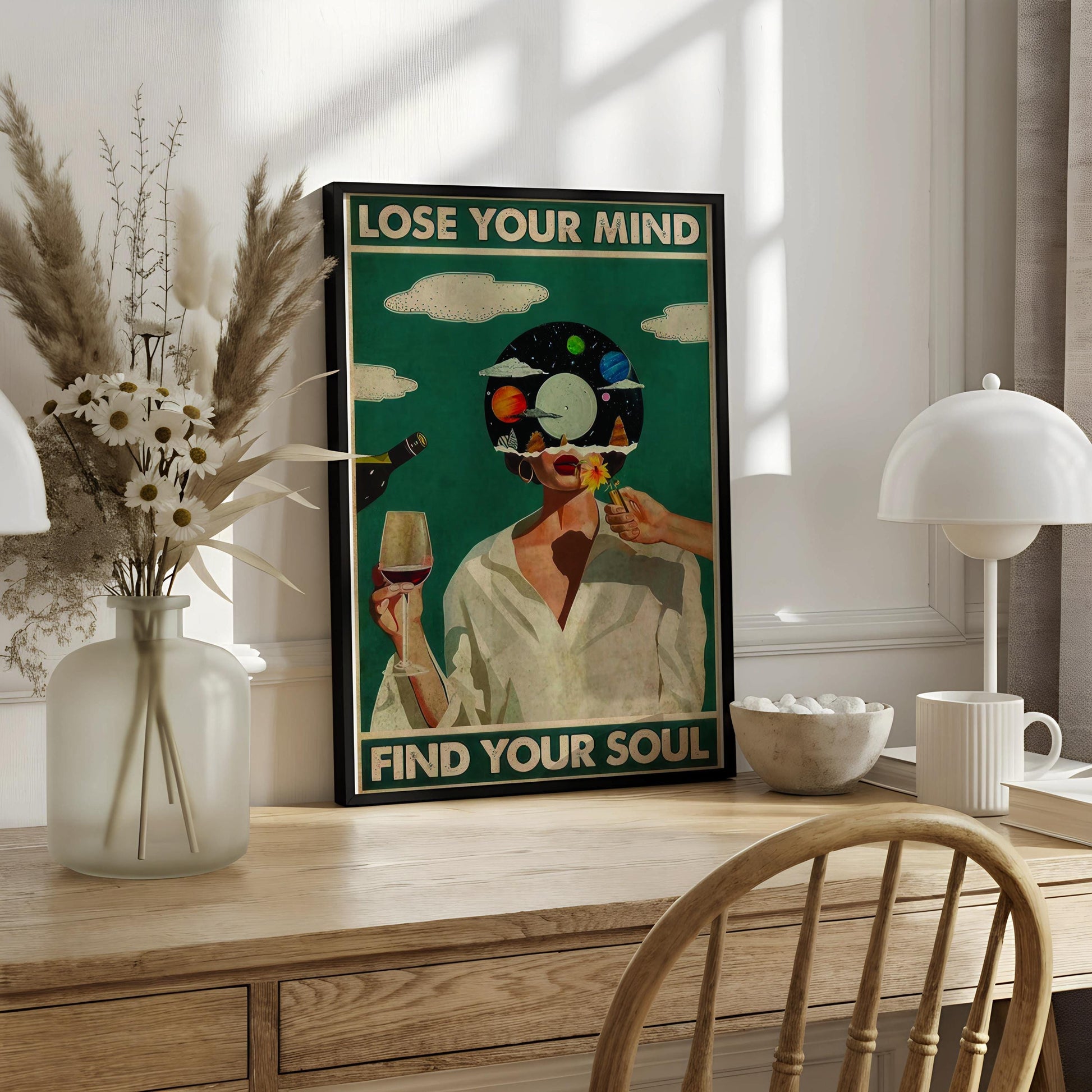 The image is a framed poster with a woman holding a wine glass and a flower, set against a backdrop of a blue sky with clouds. The text on the poster reads "LOSE YOUR MIND FIND YOUR SOUL".