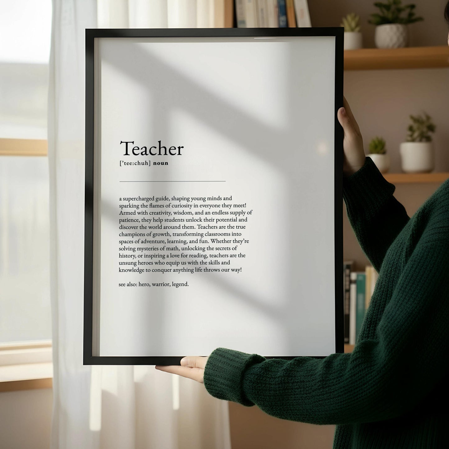 a wooden frame with a black and white text definition of a "Teacher" in a simple, elegant font.