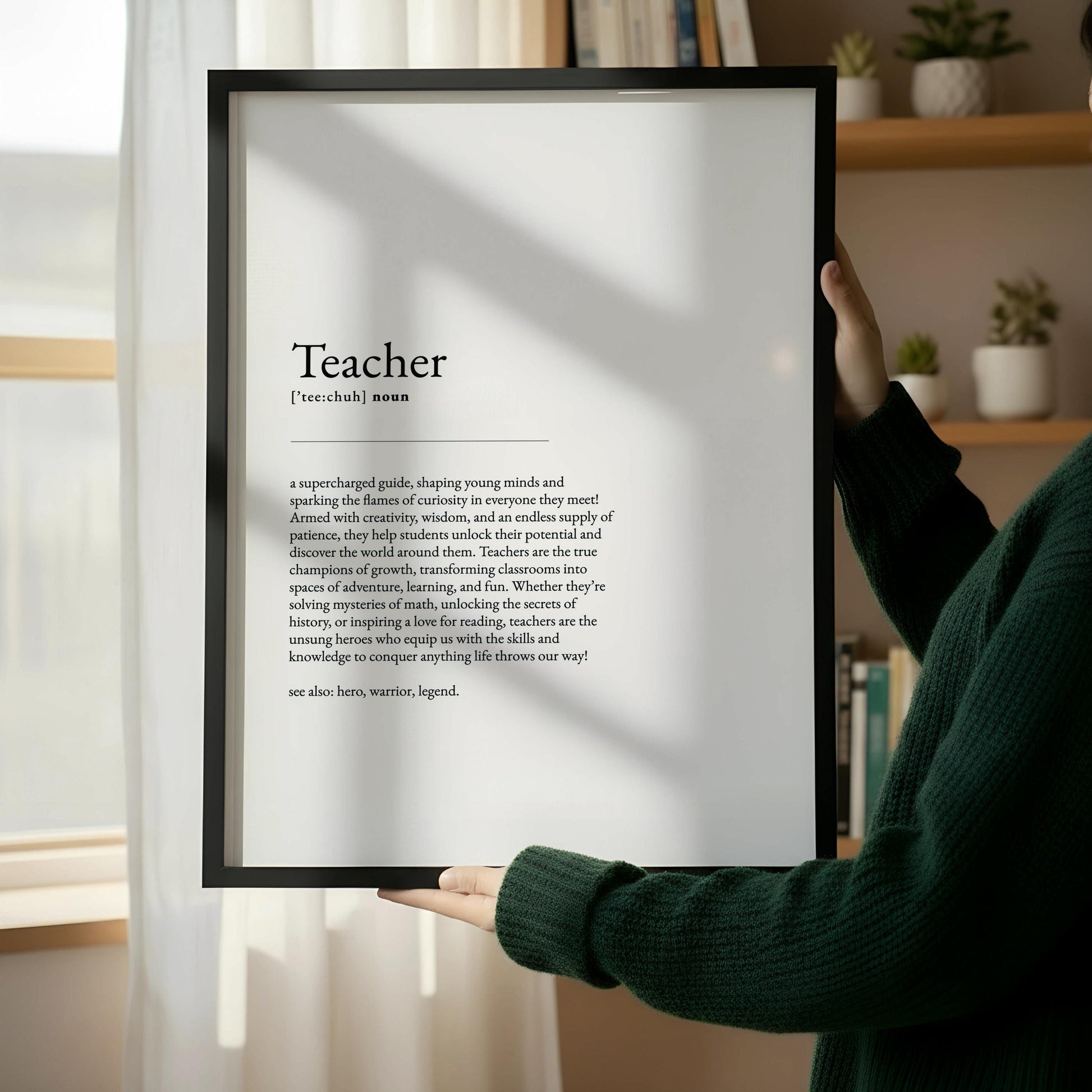 a wooden frame with a black and white text definition of a "Teacher" in a simple, elegant font.