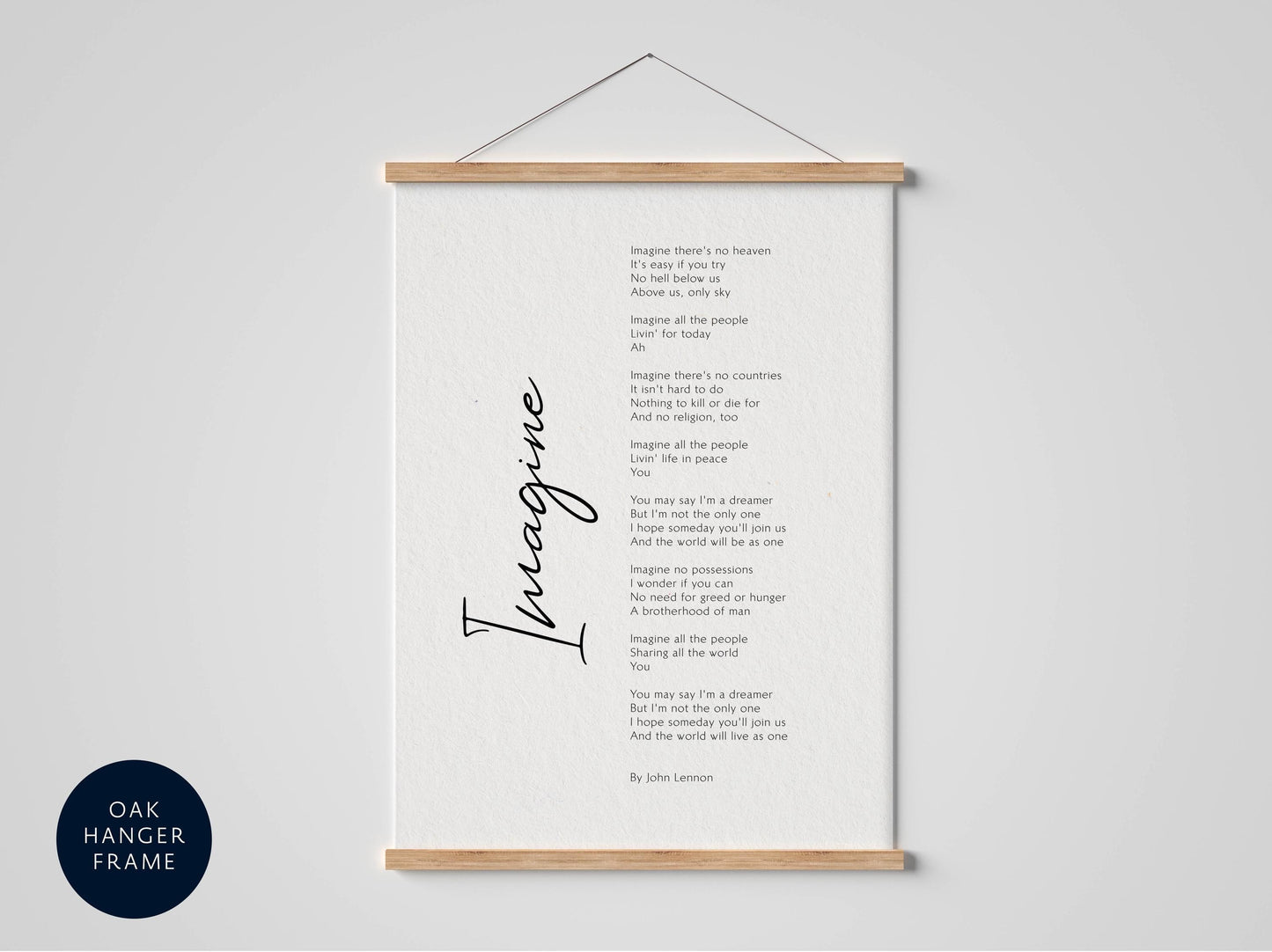 a framed black and white poem titled "Imagine" by John Lennon, which is displayed on a white wall.