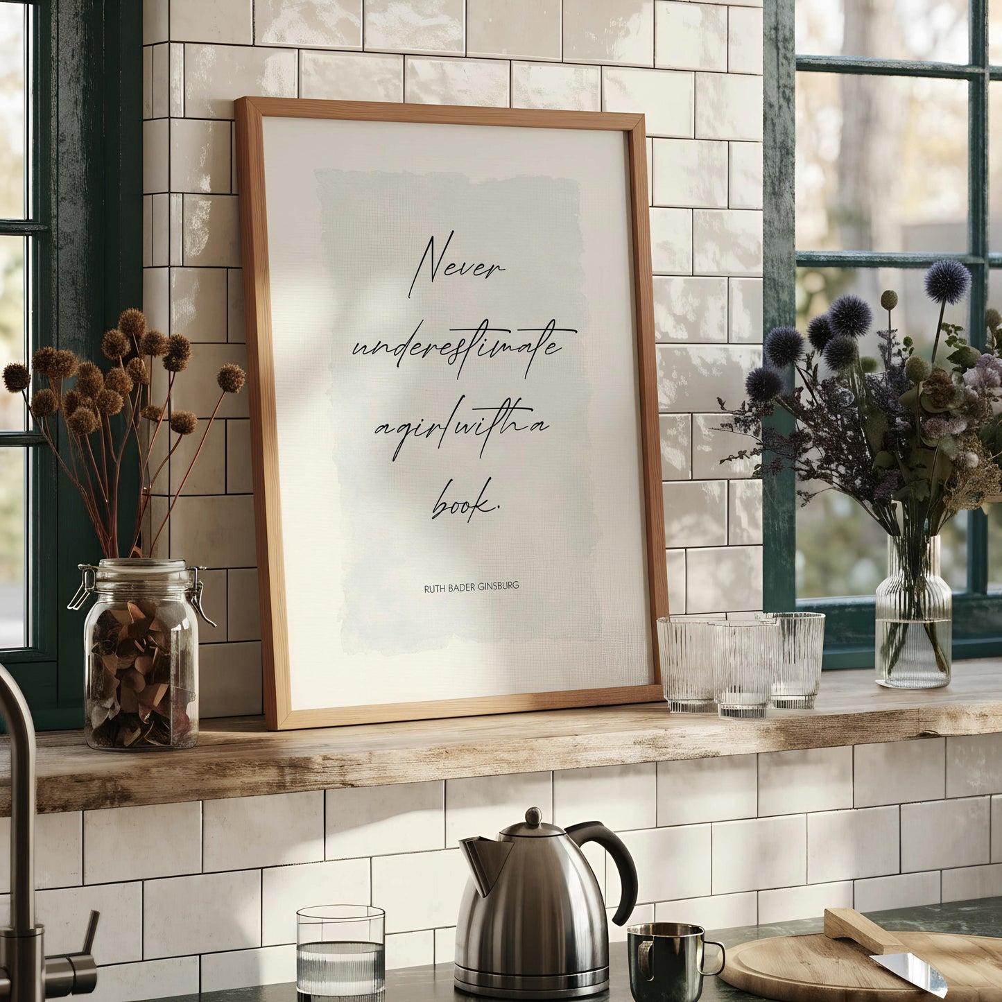 a framed quote by Ruth Bader Ginsburg, which reads "Never underestimate agirl within a book."
