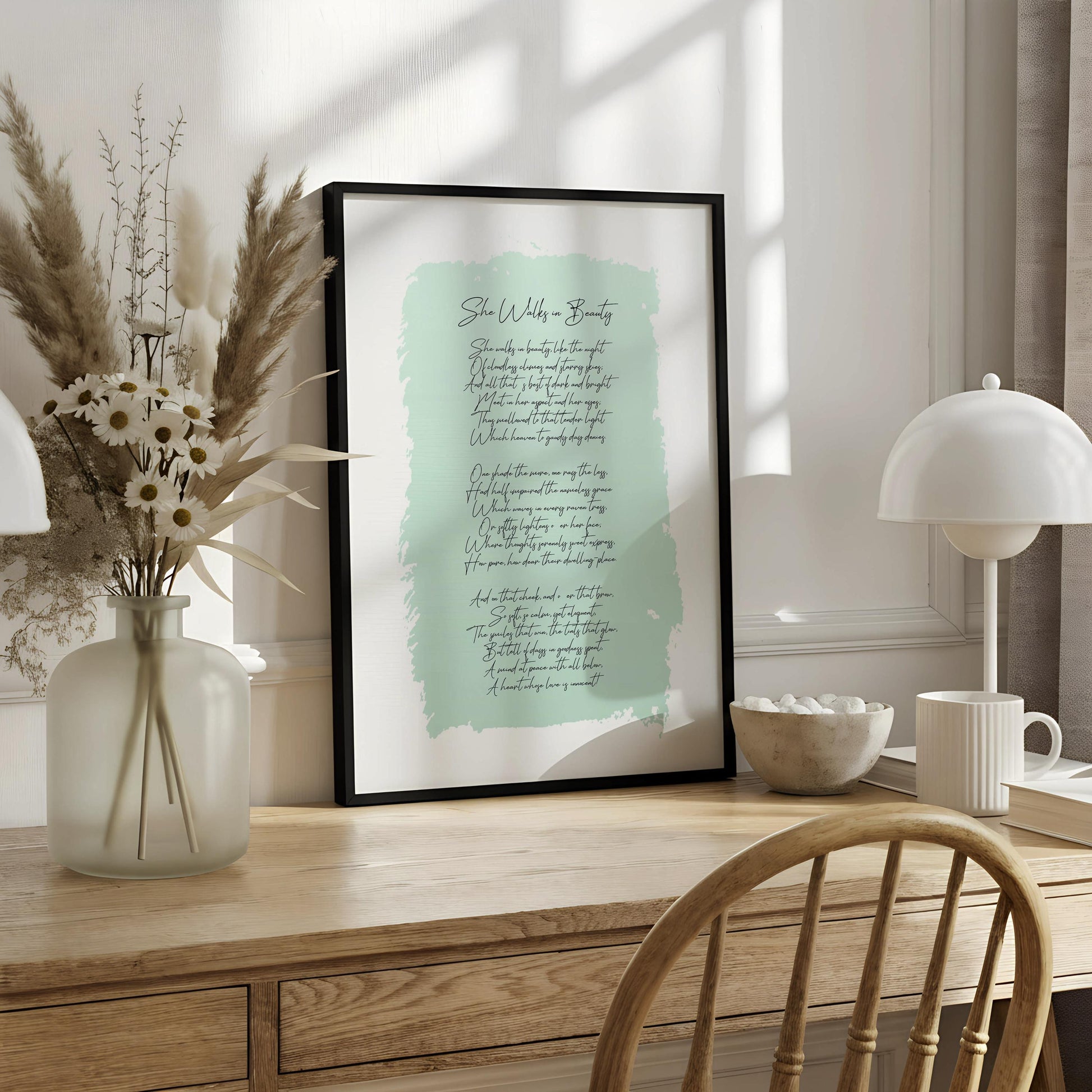A framed print with a light blue background and cursive text, titled "She walks in beauty".
