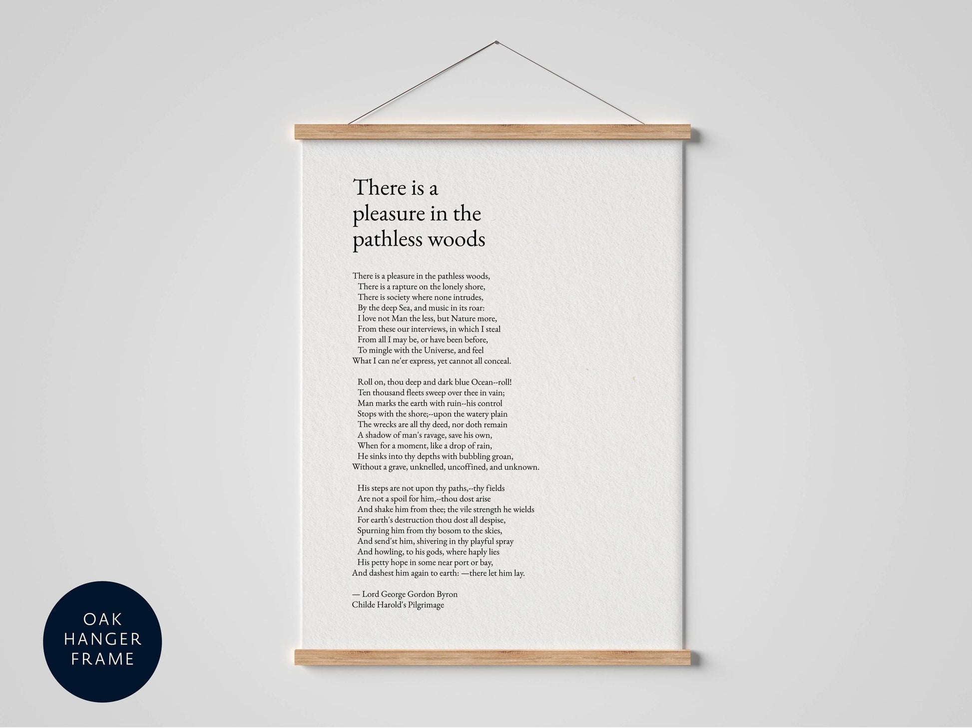 a framed poem titled "There is a pleasure in the pathless woods" by Charles Middleton Byron.