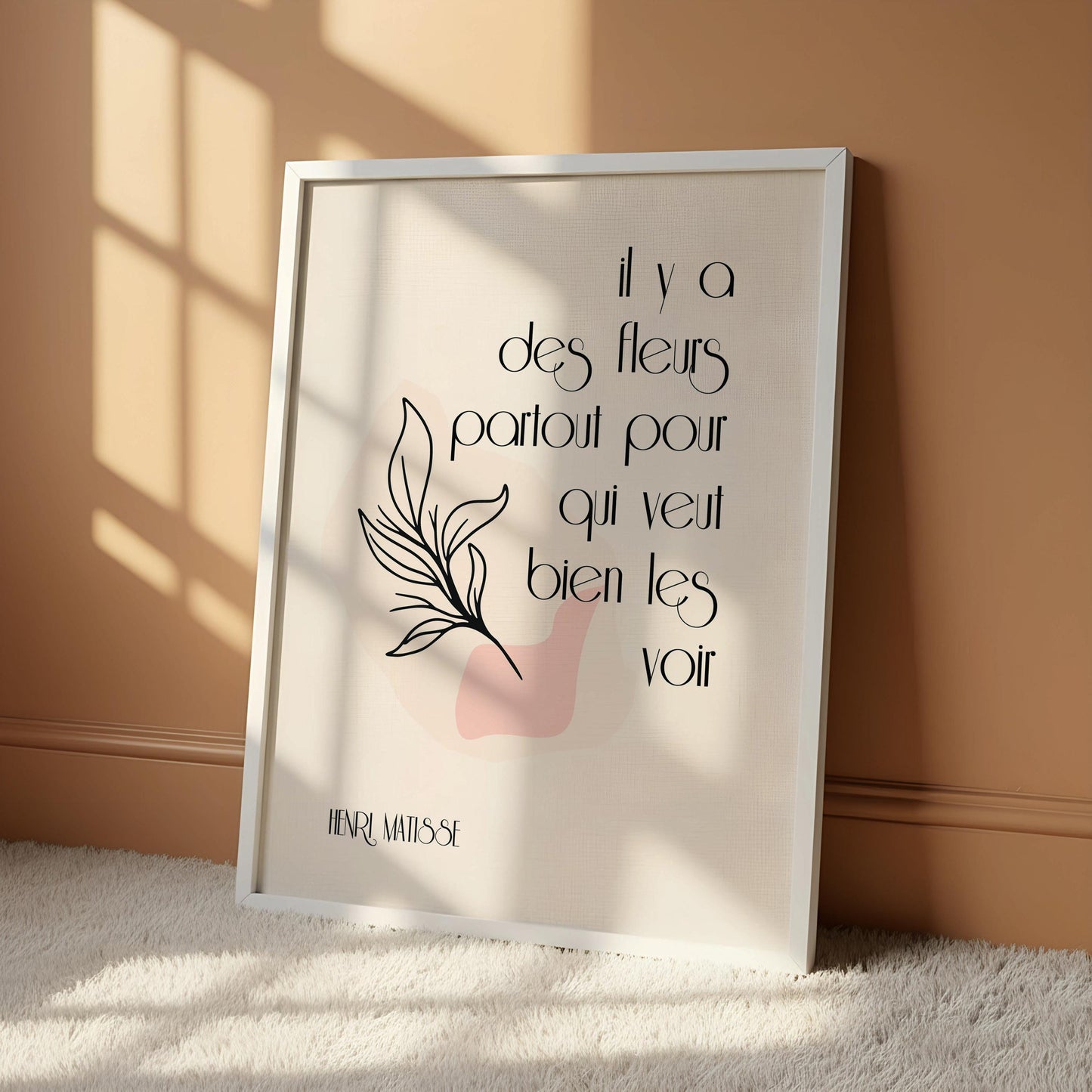 a framed poster with a quote on it, placed next to a wooden chair on a wooden floor.