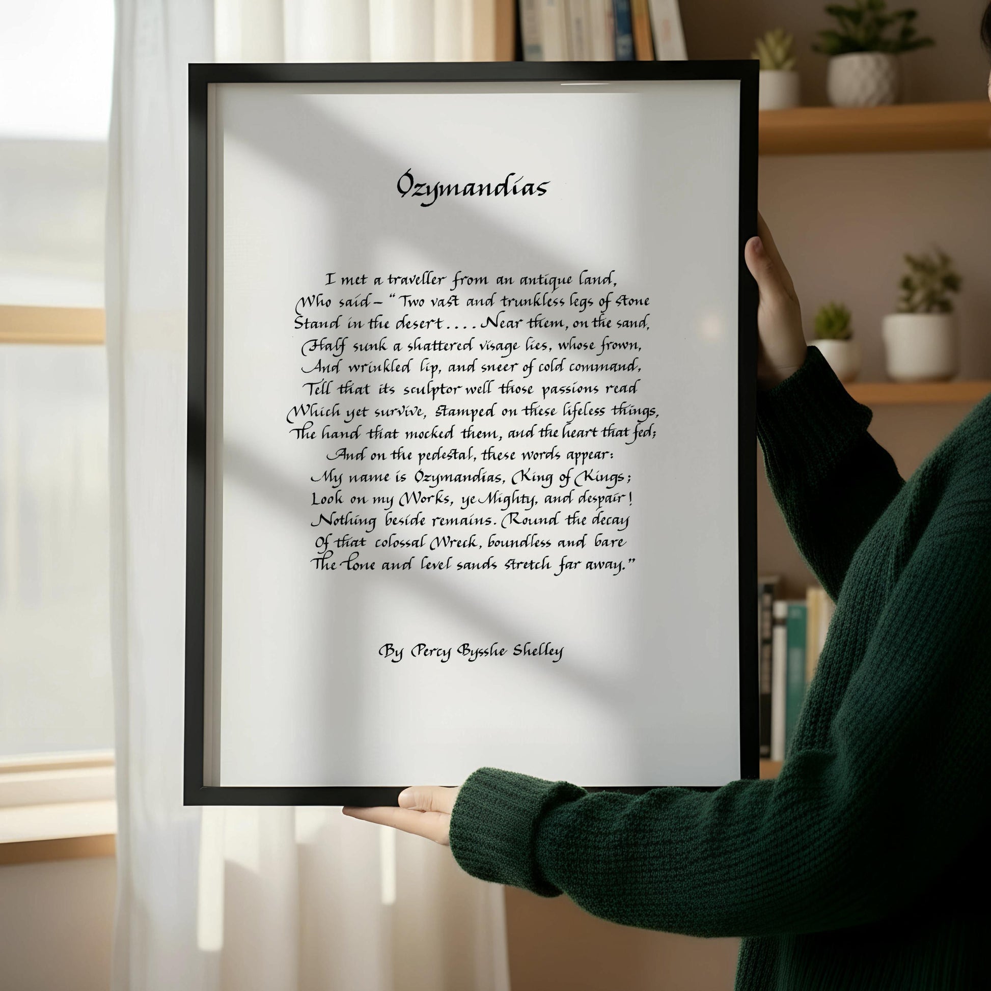 a framed poem titled "Ozymandias" by Percy Shelley, placed on a wooden floor next to a wooden chair.