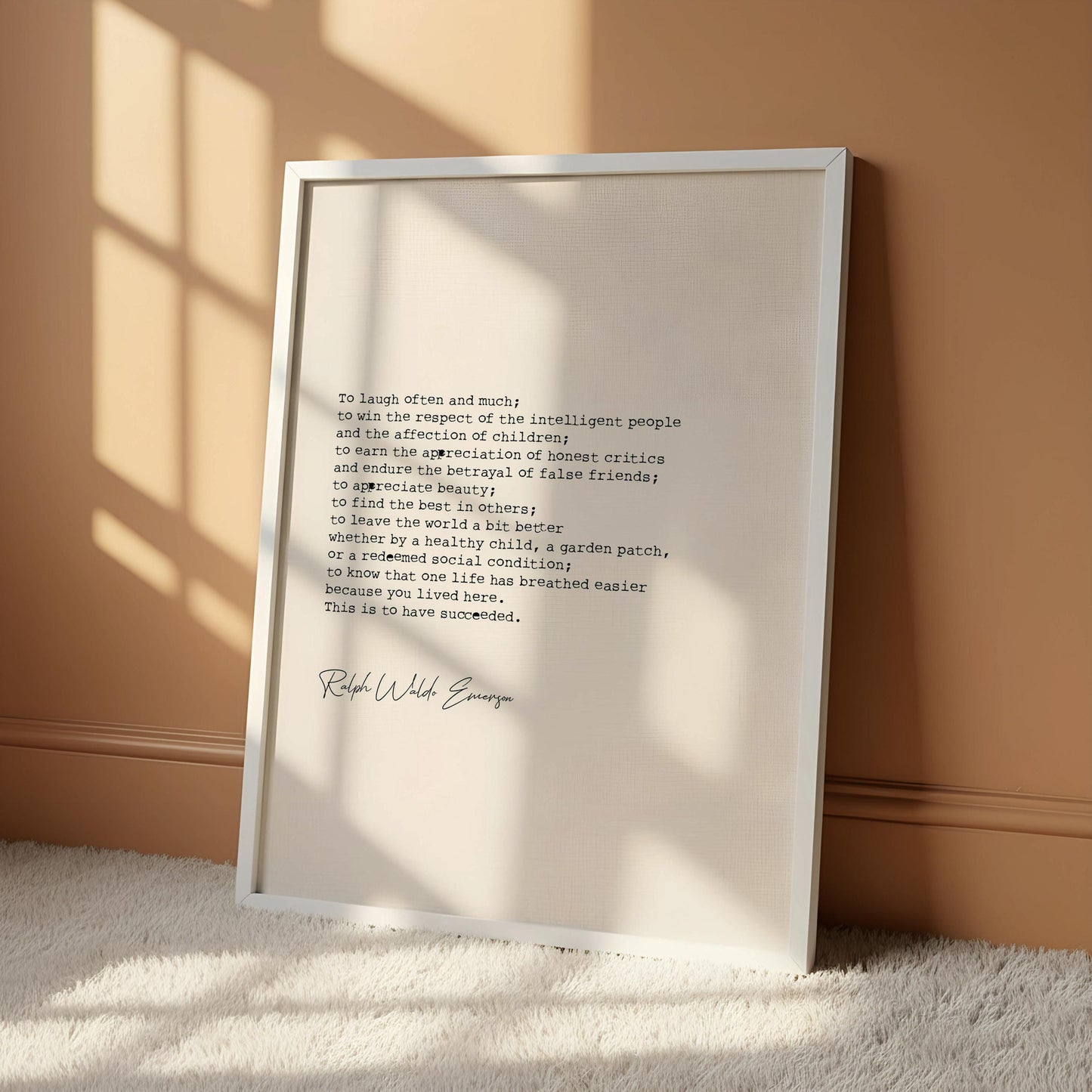 a framed quote by Ralph Waldo Emerson, which is a piece of literature. The quote is written in a black text on a white background, and it is hanging on a wall. The quote is accompanied by a logo for the Hanger Frame, which is a company that provides frame solutions for various types of artwork.