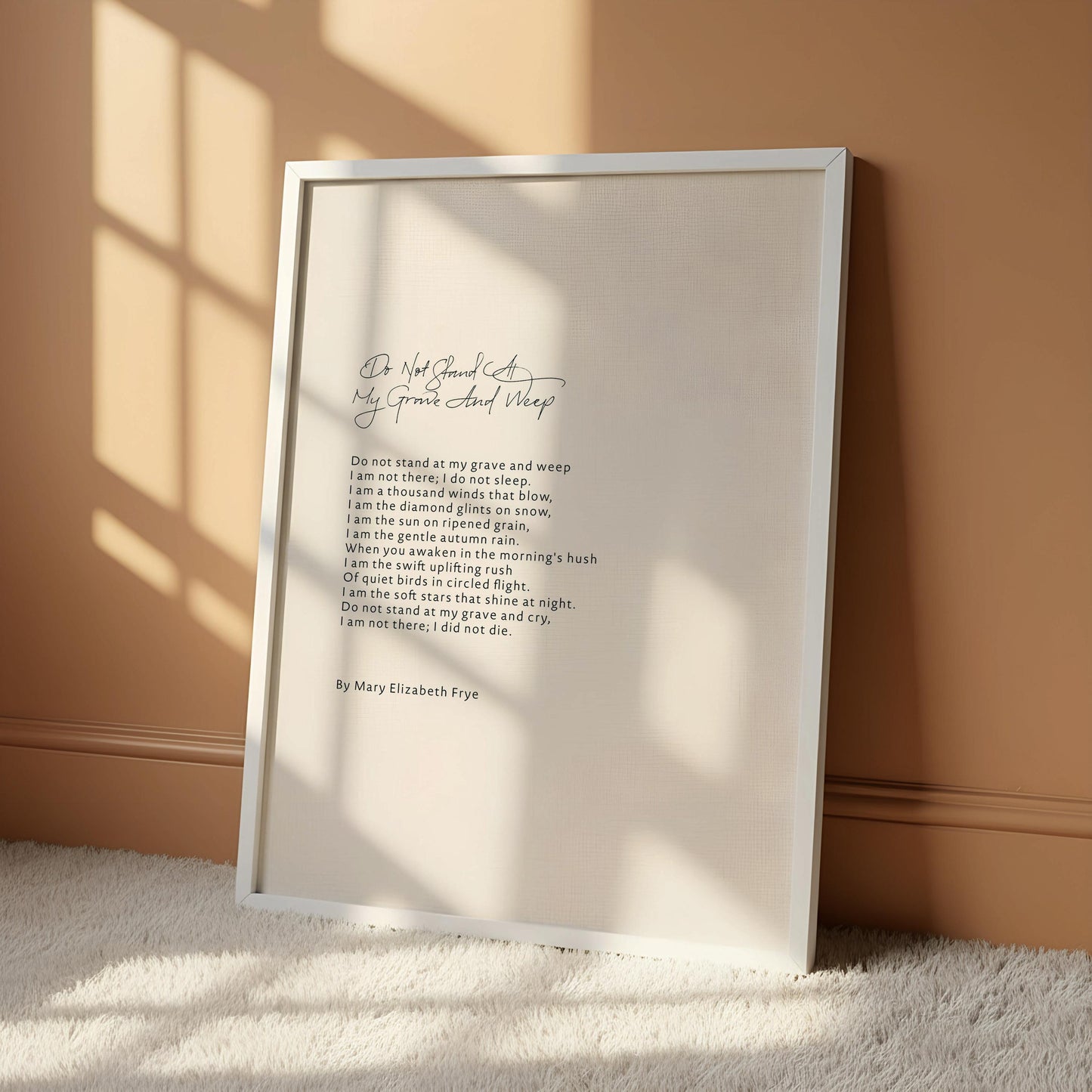a framed poem titled "Do not stand at grave and wake" by Elizabeth Fry, which is displayed on a white wall.