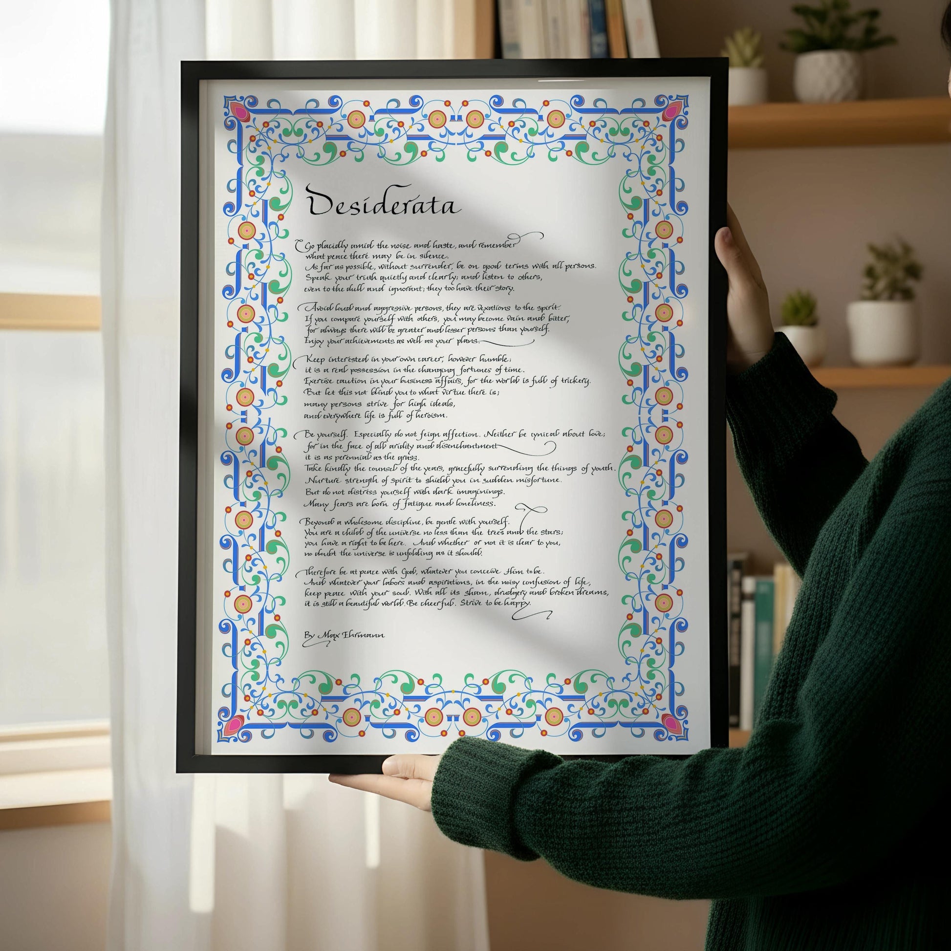 a framed print with a decorative border and ornate lettering, which appears to be a poem or a religious text.
