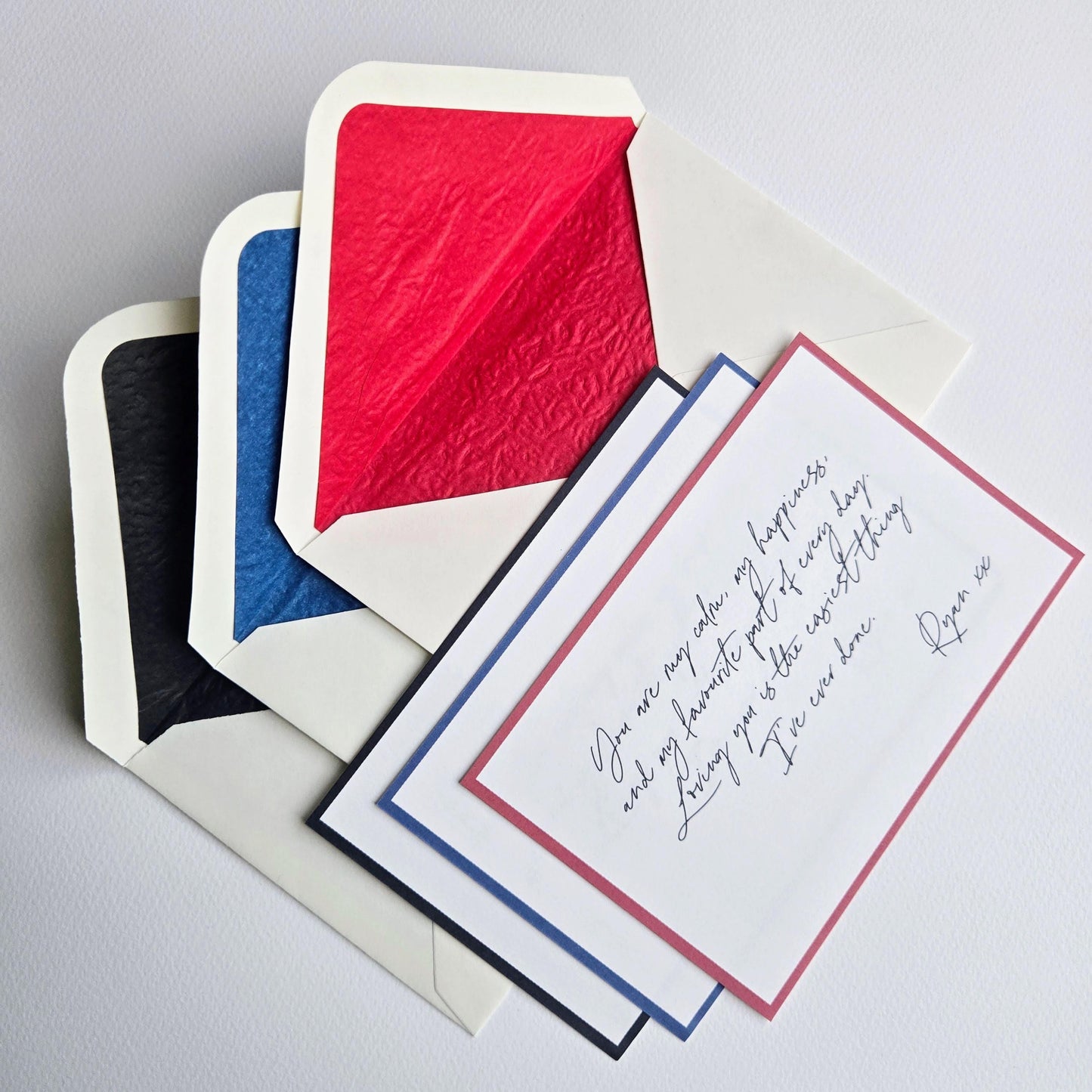 three envelopes with a handwritten note attached to one of them.