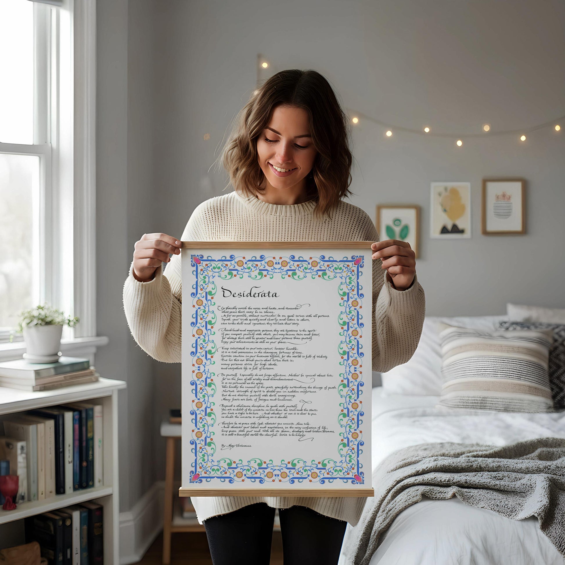 a framed poem titled "Dissiderta" leaning against a white wall, with a wooden chair and a stack of books placed next to it on a wooden floor.