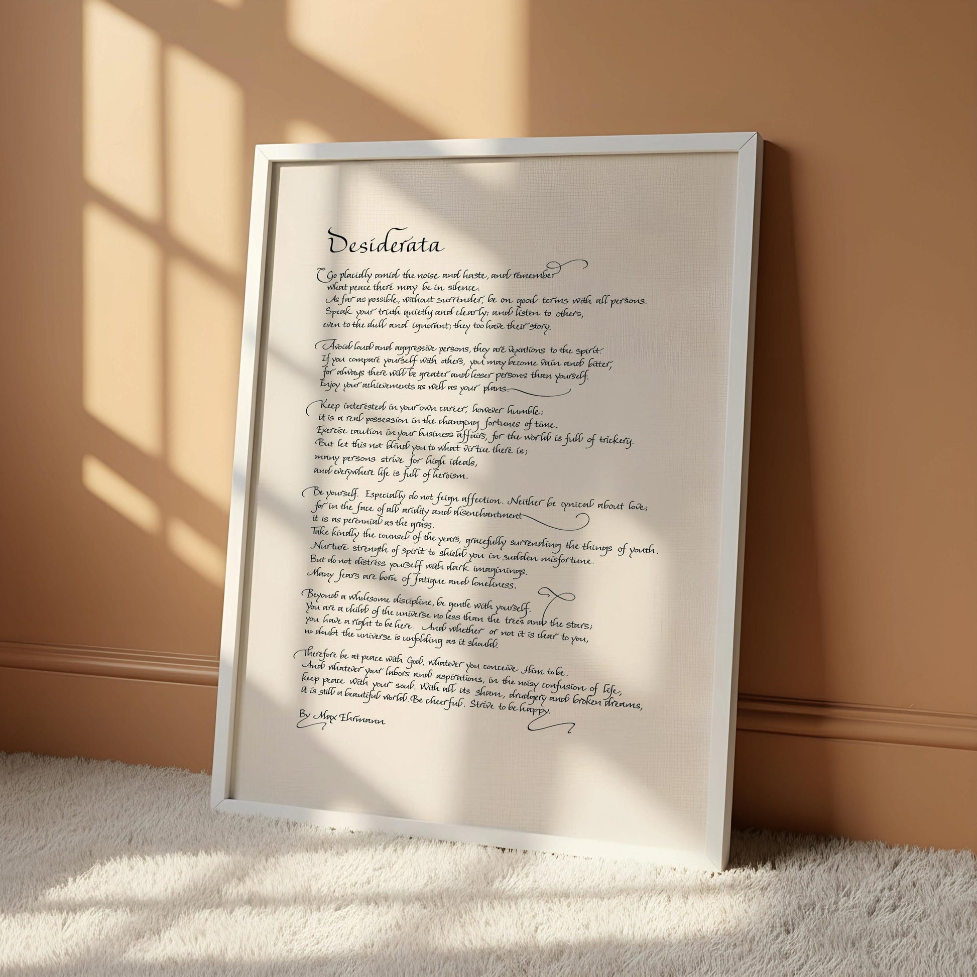 a handwritten poem on a white scroll, which is mounted on a wall.