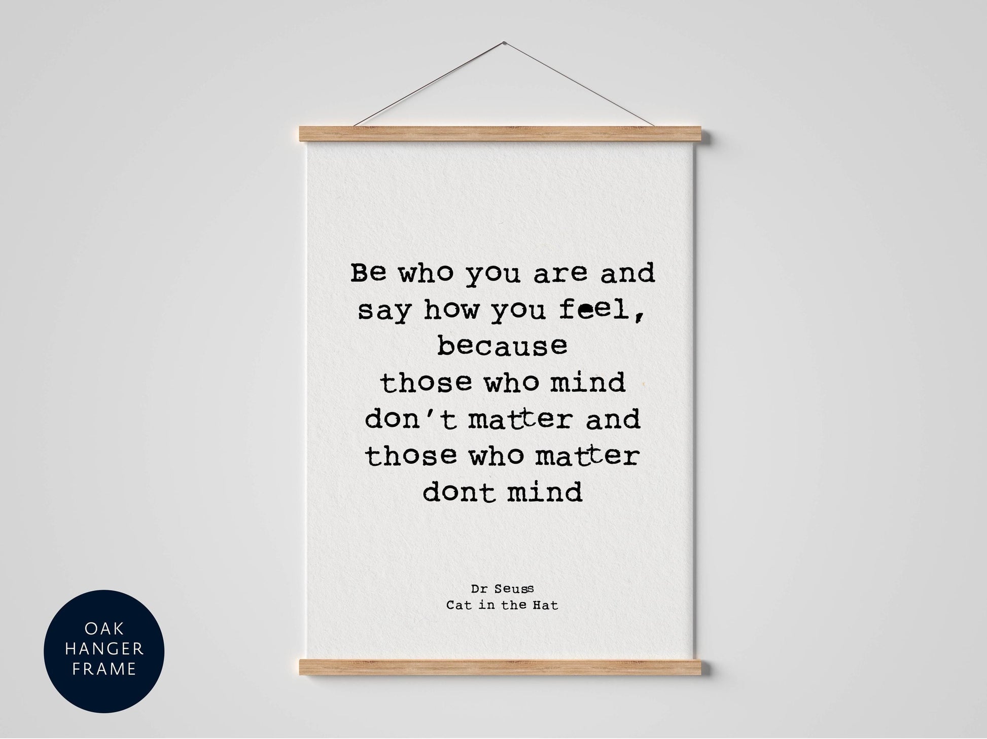 a framed quote by Dr. Seuss, "Cat in the Hat", placed on a white wall.