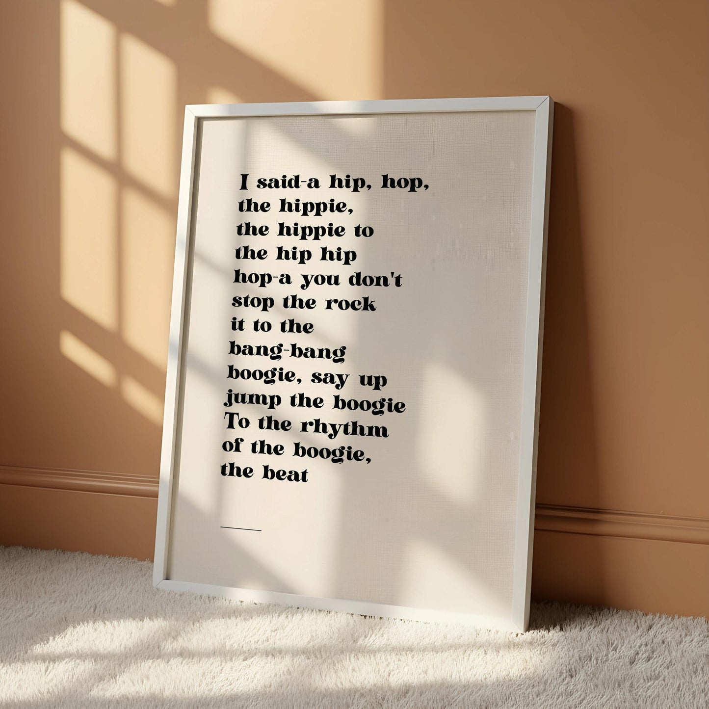 a wooden chair with a framed quote on the wall next to it.