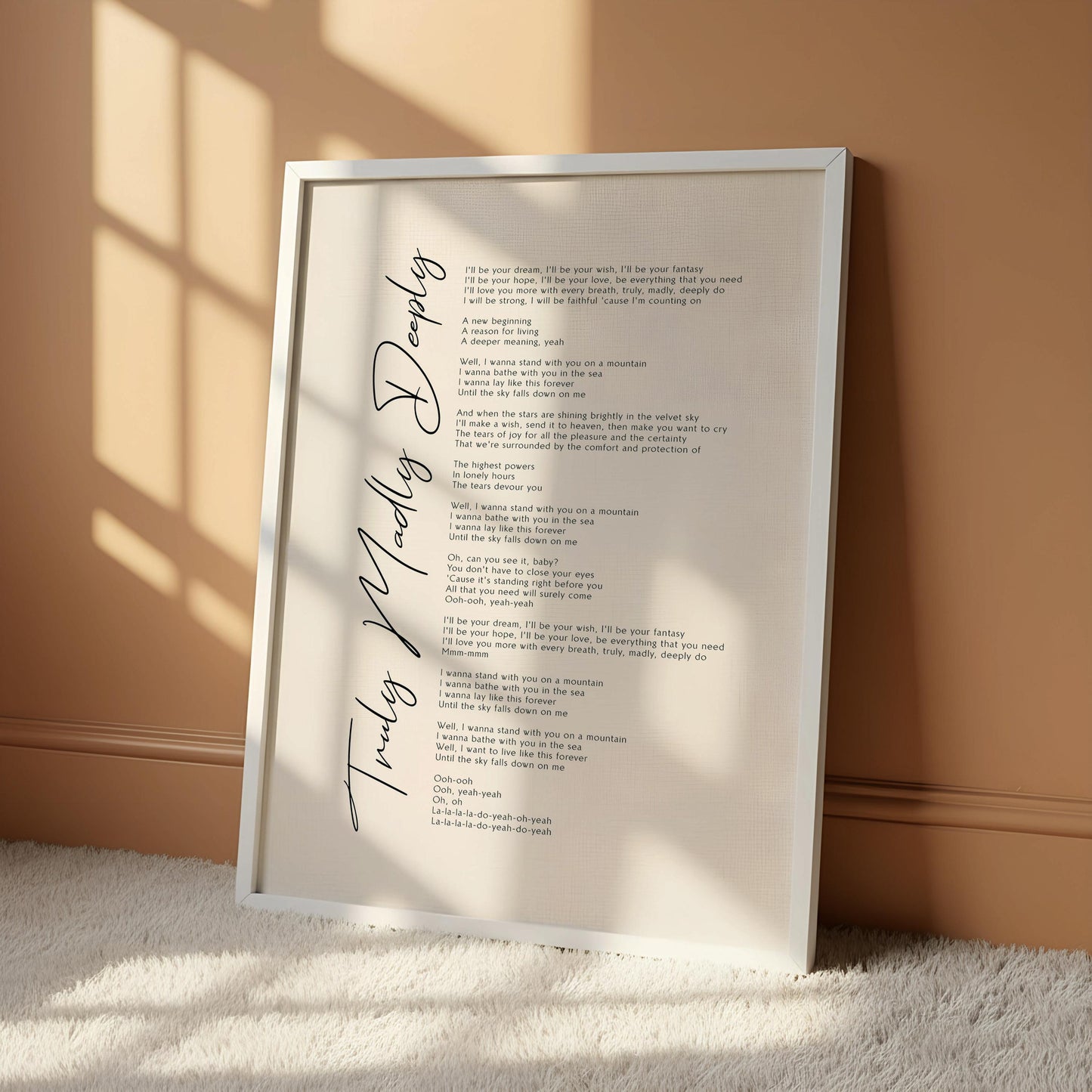 a framed print of a song titled "Truly Madly Deeply" hanging on a wall.